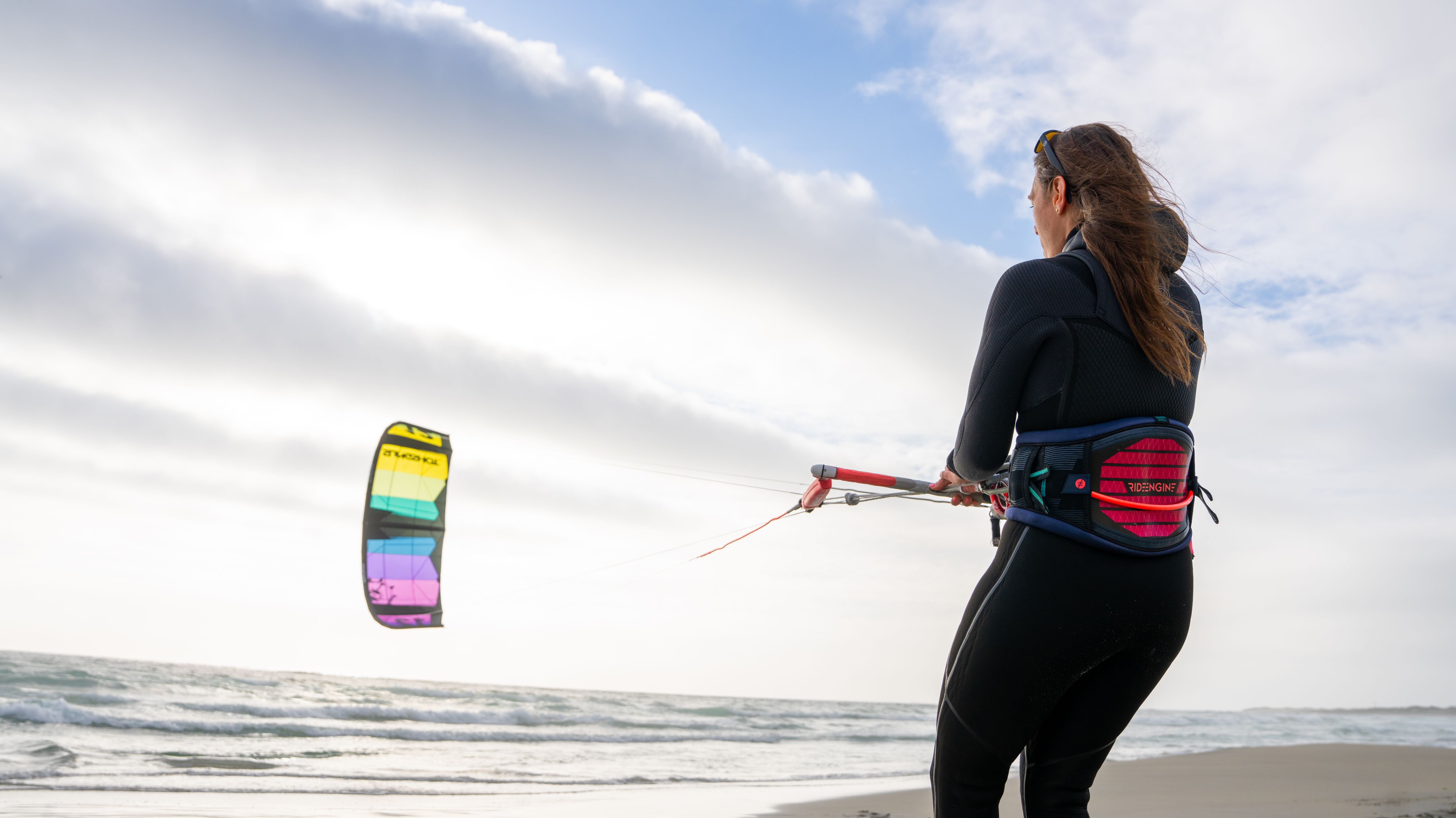A woman kiting at a beach outside Stavanger, Fjord Norway.