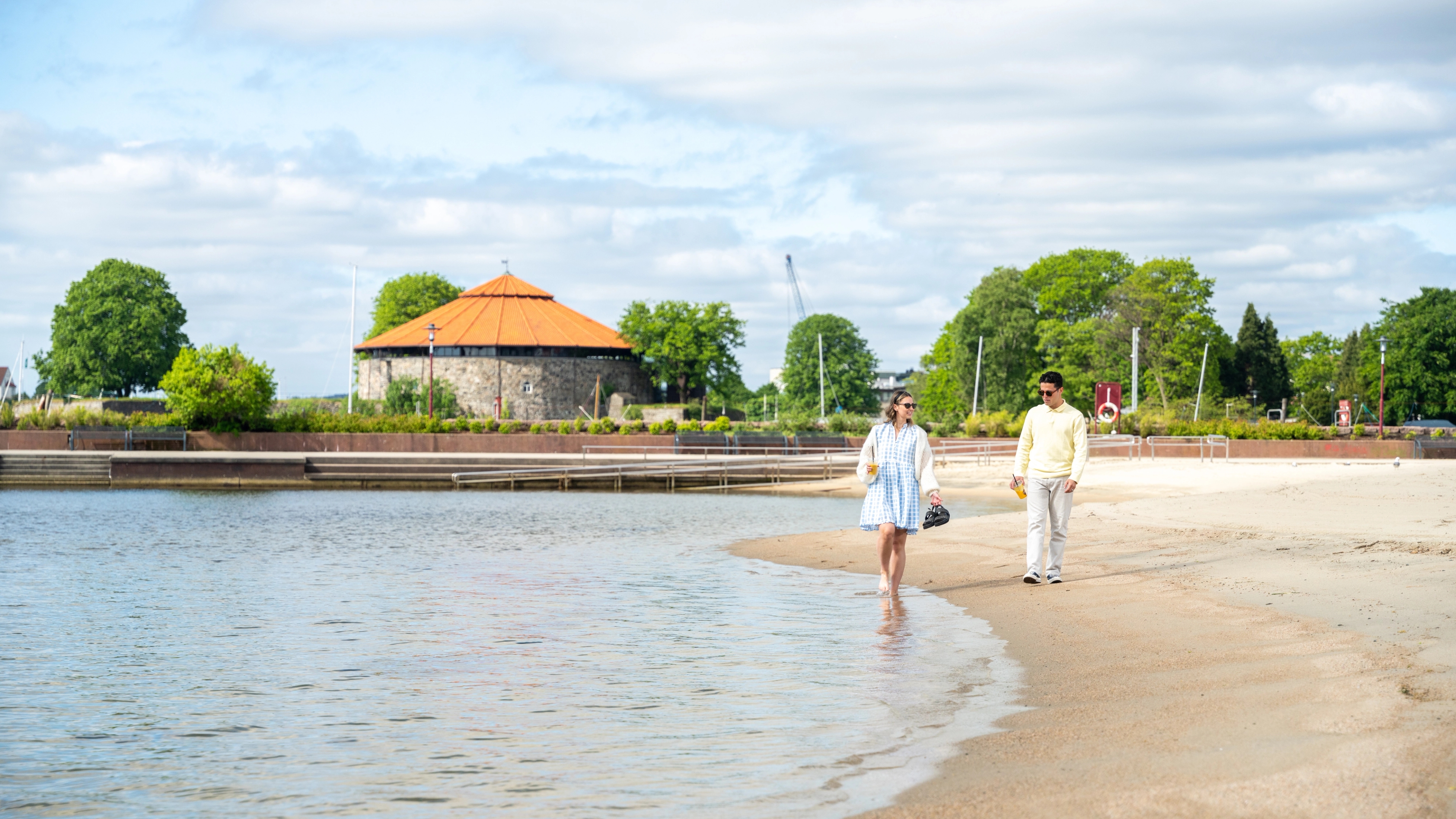 Two friends walking on the Bystranda beach in Kristiansand, Southern Norway
