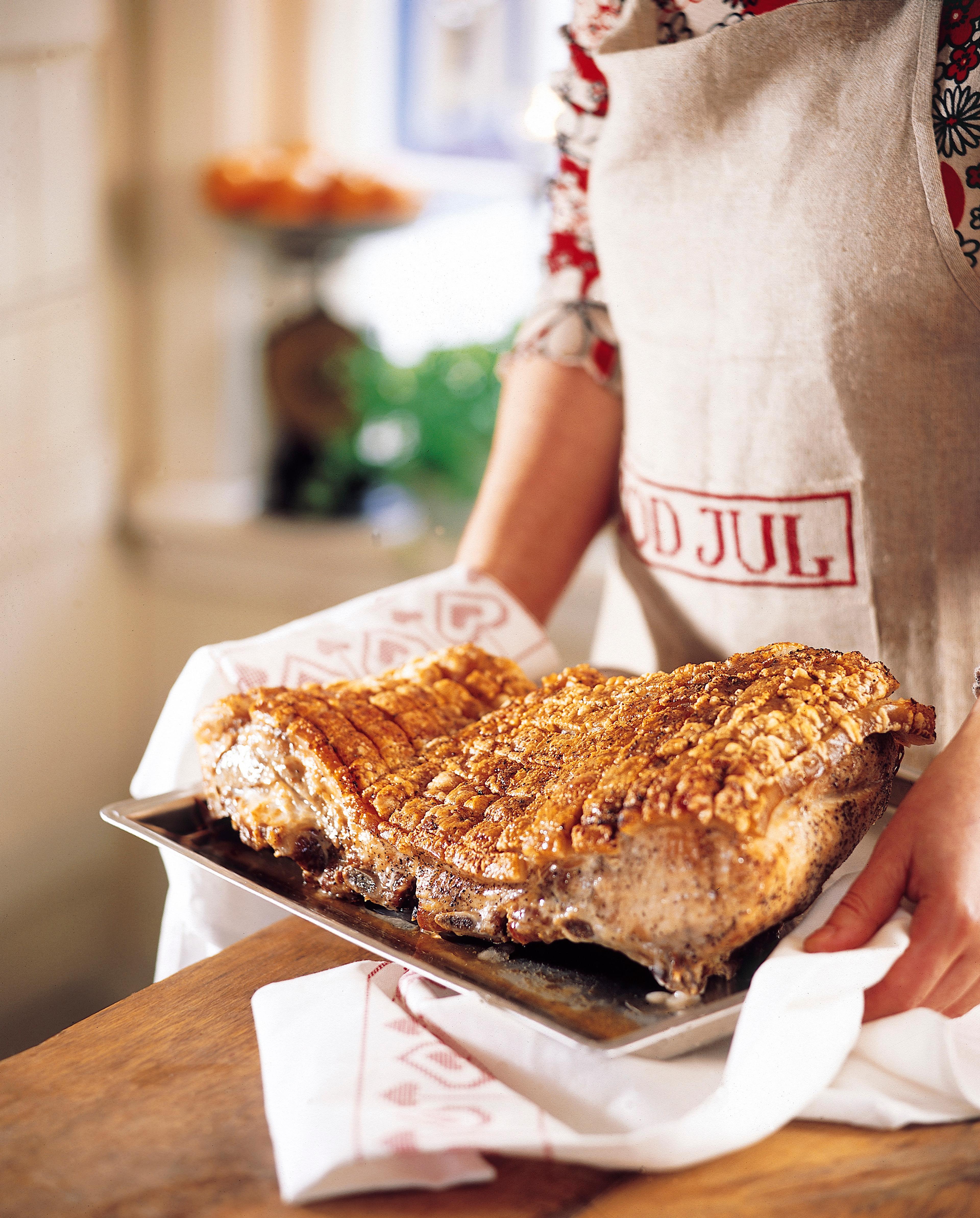 A person holding a pork rib