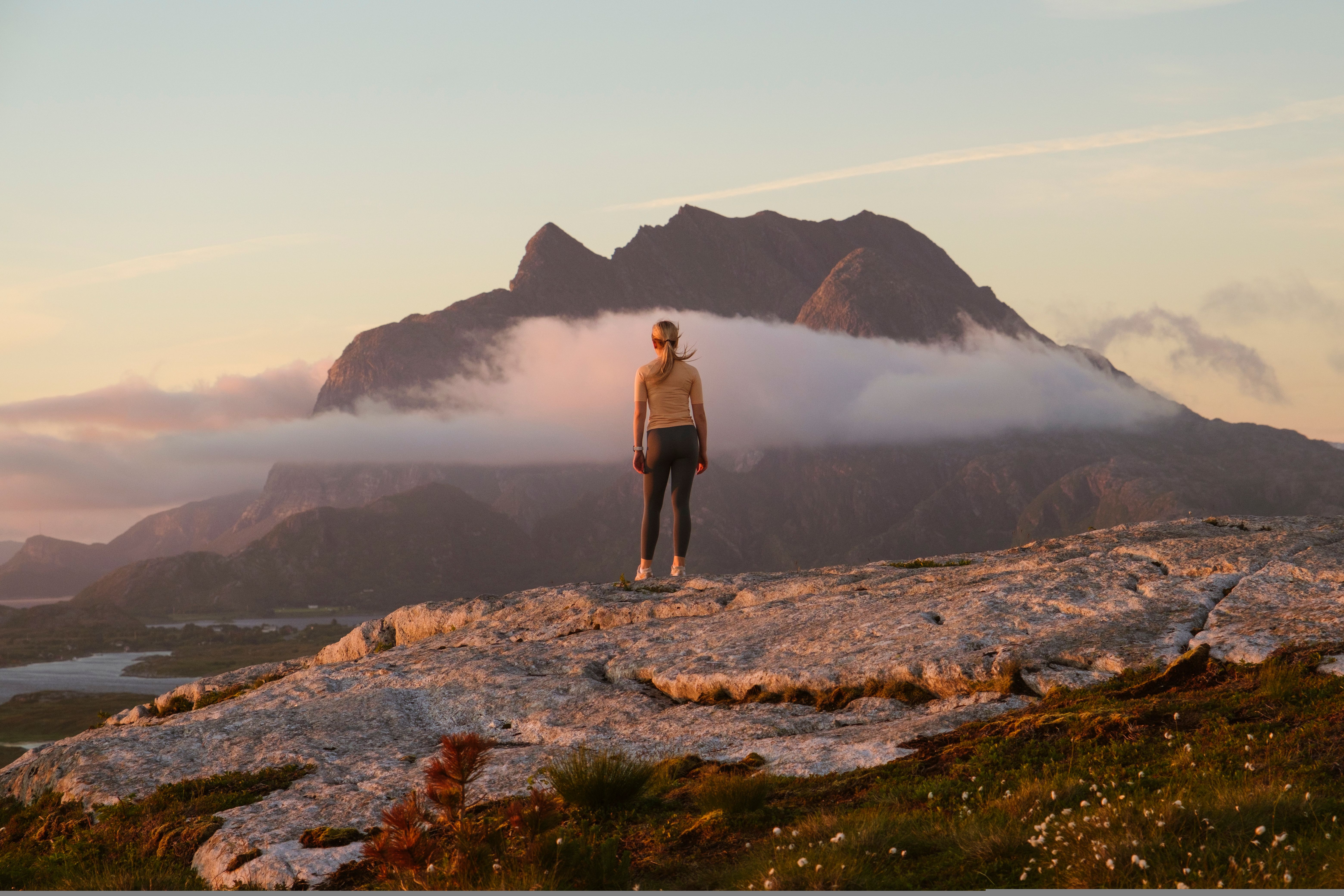 A woman going on a midnight hike to Øksningan, Helgeland, Norway.