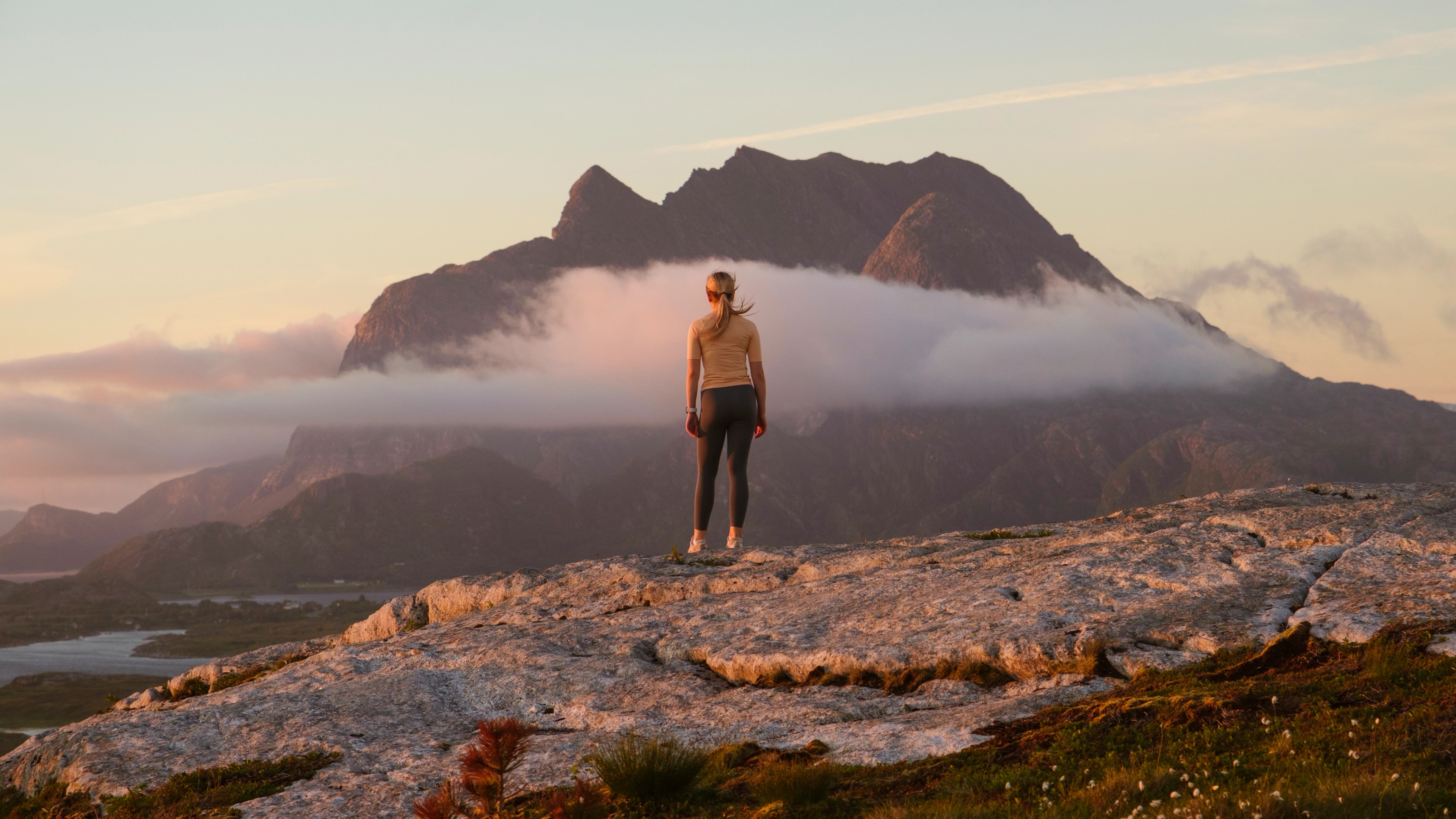 A woman going on a midnight hike to Øksningan, Helgeland, Norway.