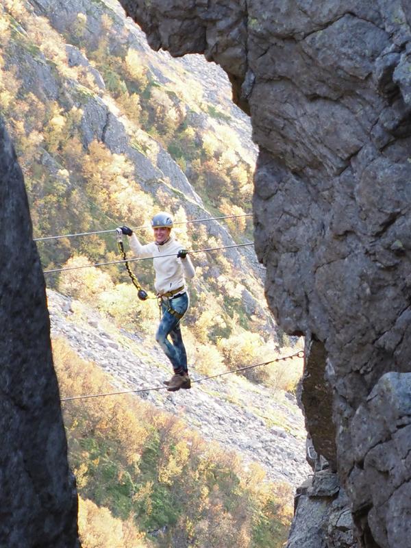 Woman climbing via ferrata Ravnfloget