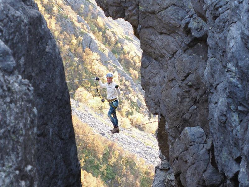 Woman climbing via ferrata Ravnfloget