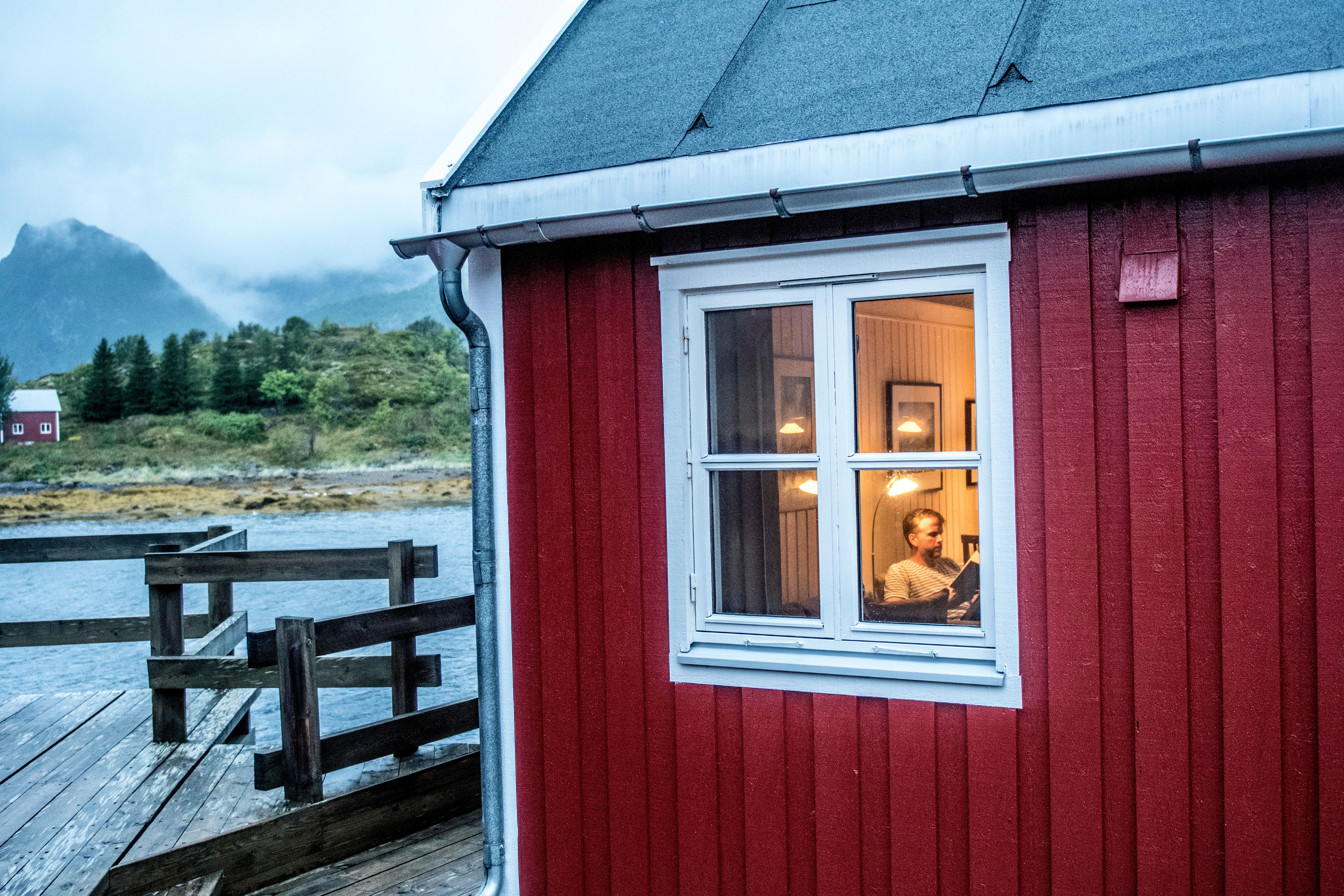 A man sitting in a fisherman's cabin in Lofoten, Northern Norway