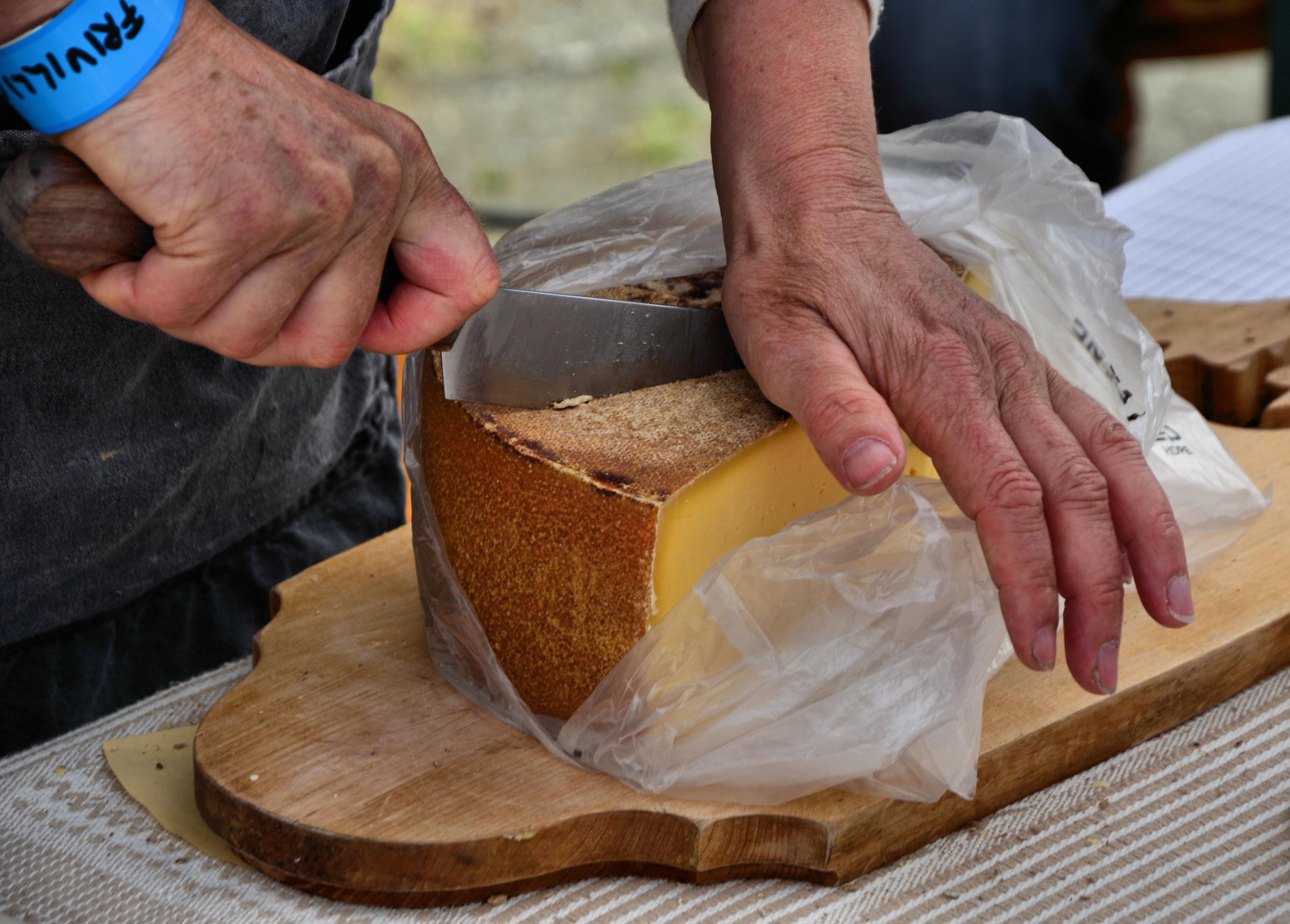 Hands cutting cheese