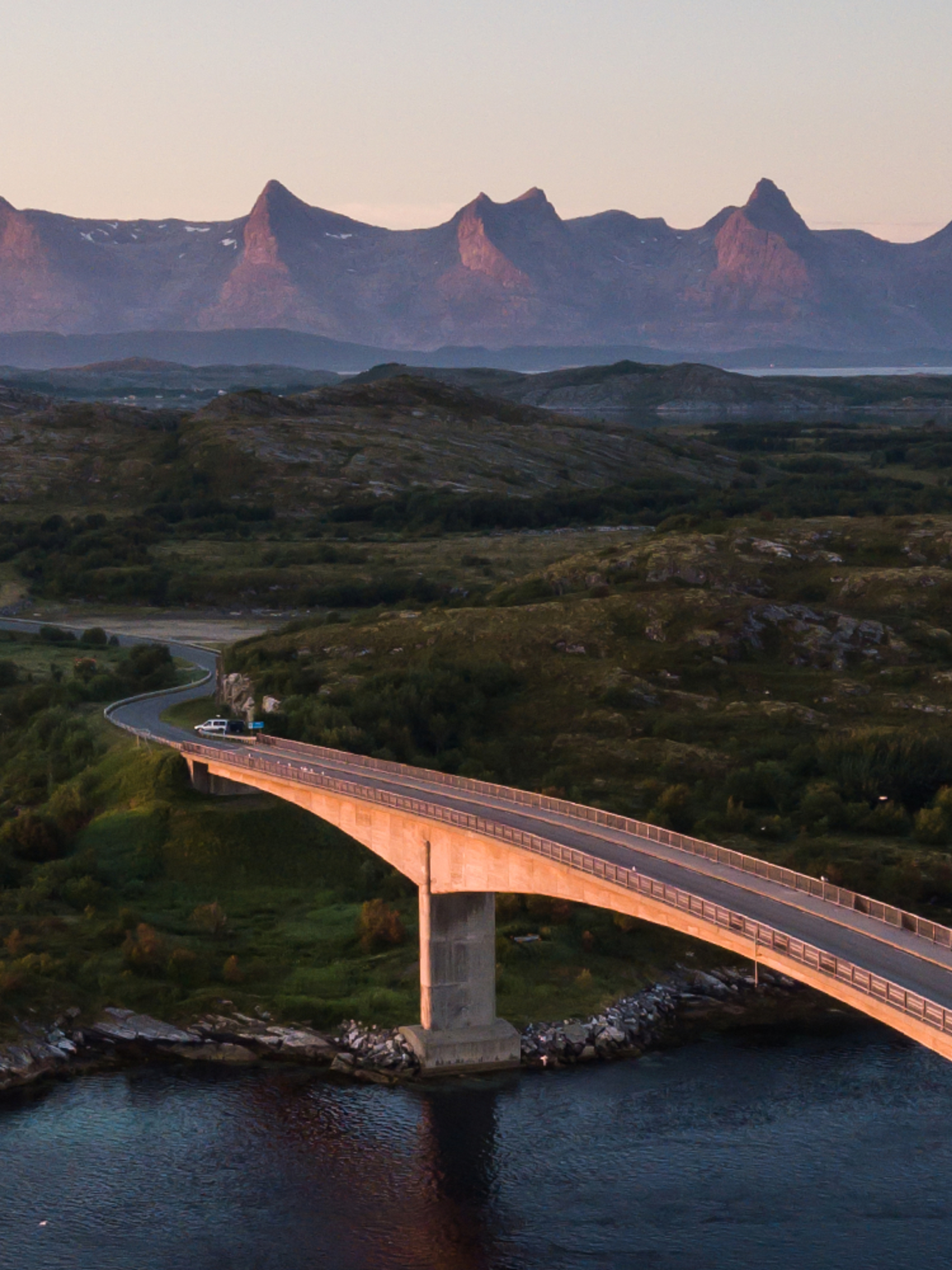 A bridge connecting Herøy to another island in Helegeland, Northern Norway. In the background, the mountain range The seven sisters.