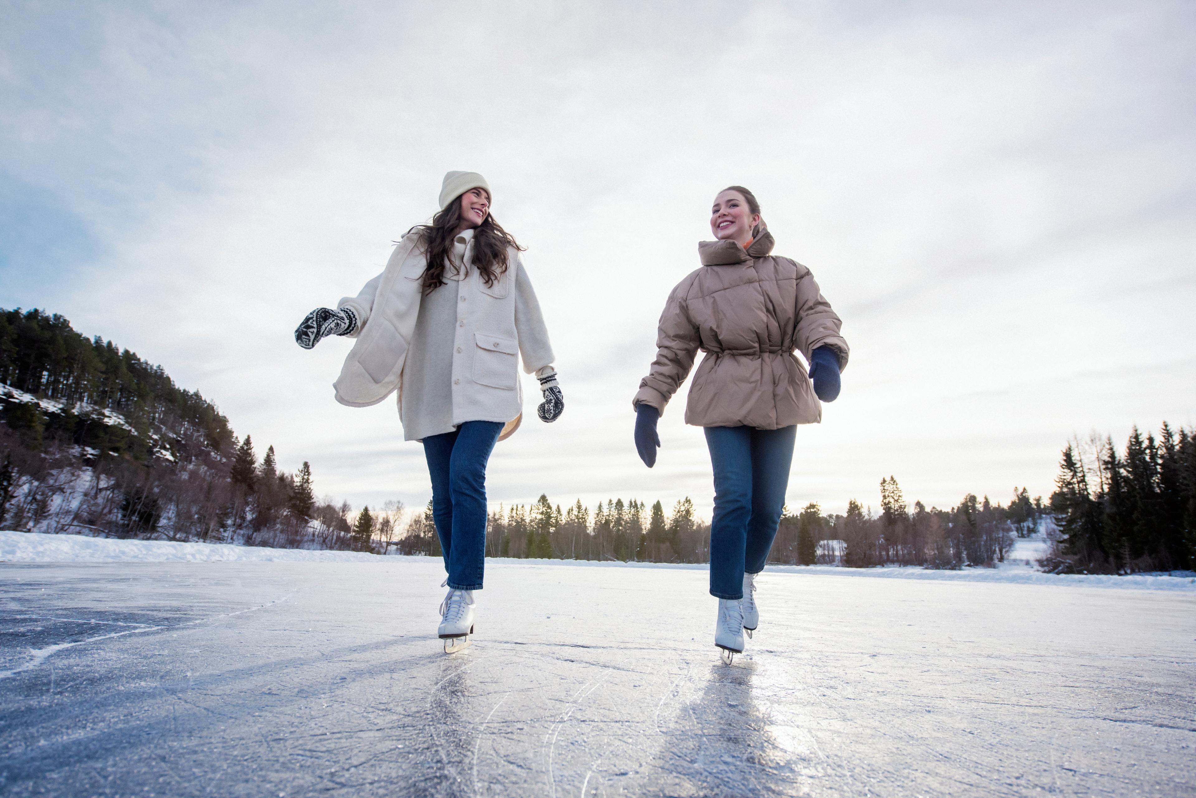 Two girls going ice skating, Trøndelag, Norway.