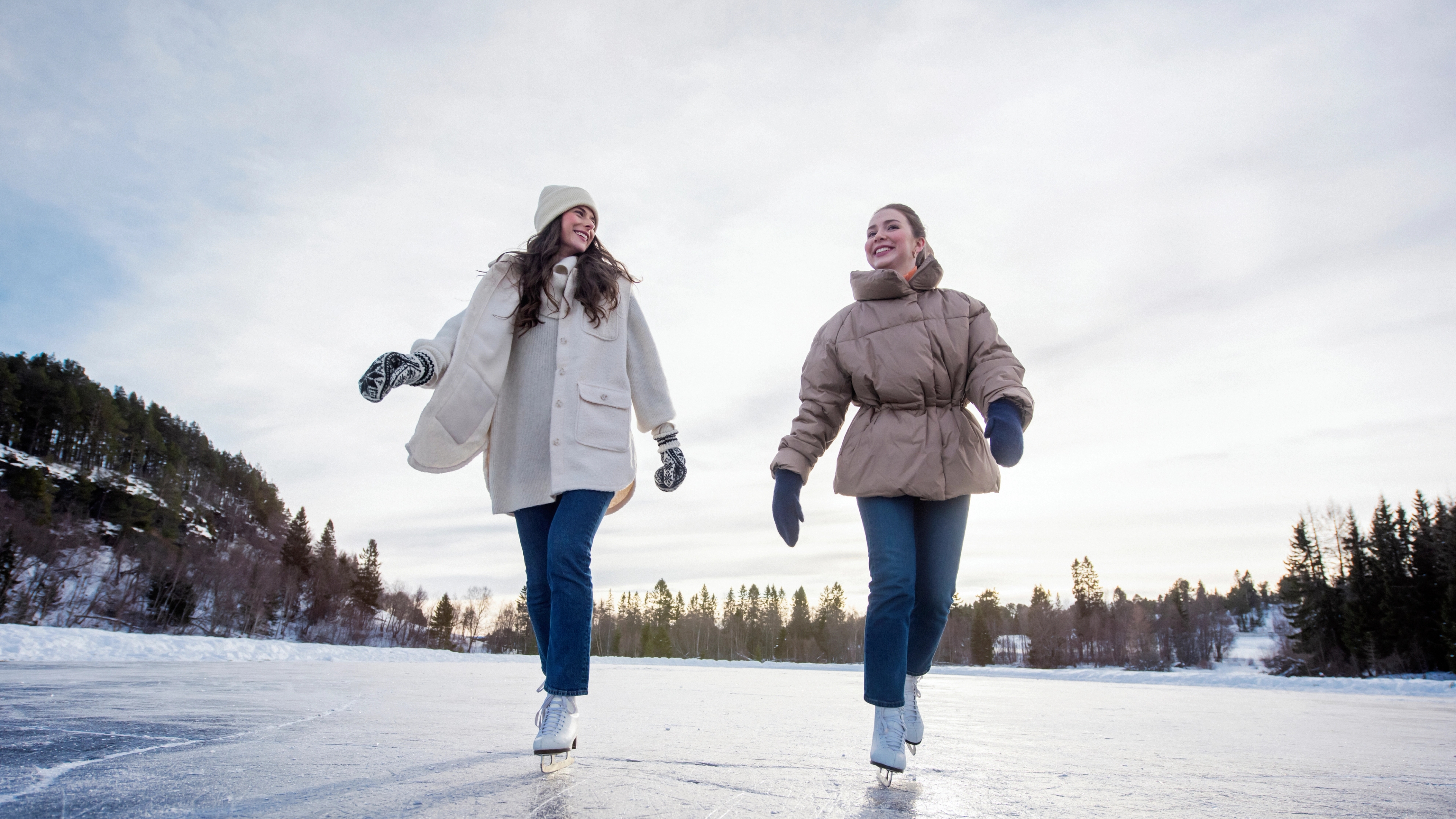 Two girls going ice skating, Trøndelag, Norway.