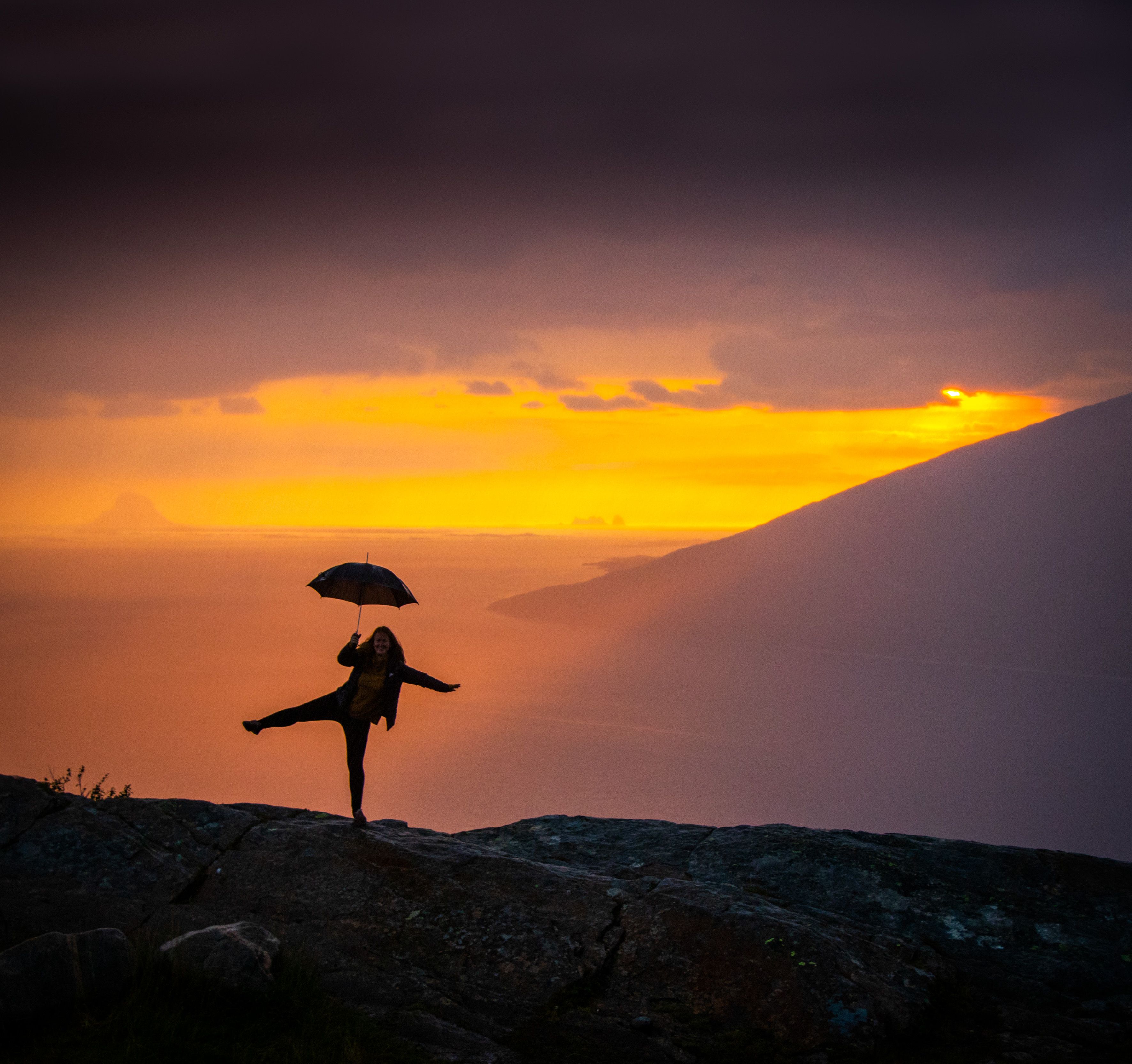 Girl holding an umbrella at the Sjonfjellet mountain in Northern Norway
