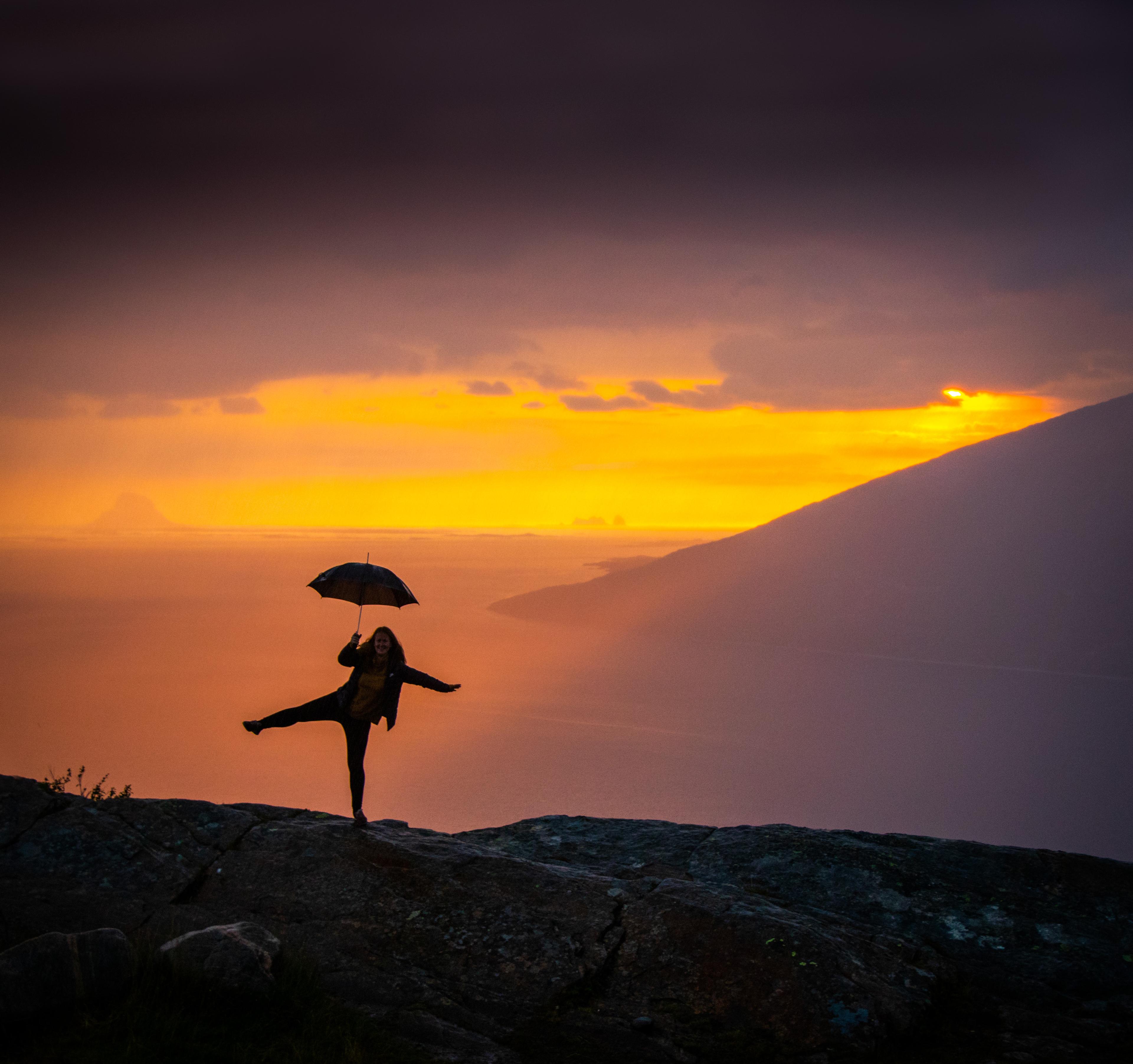 Girl holding an umbrella at the Sjonfjellet mountain in Northern Norway