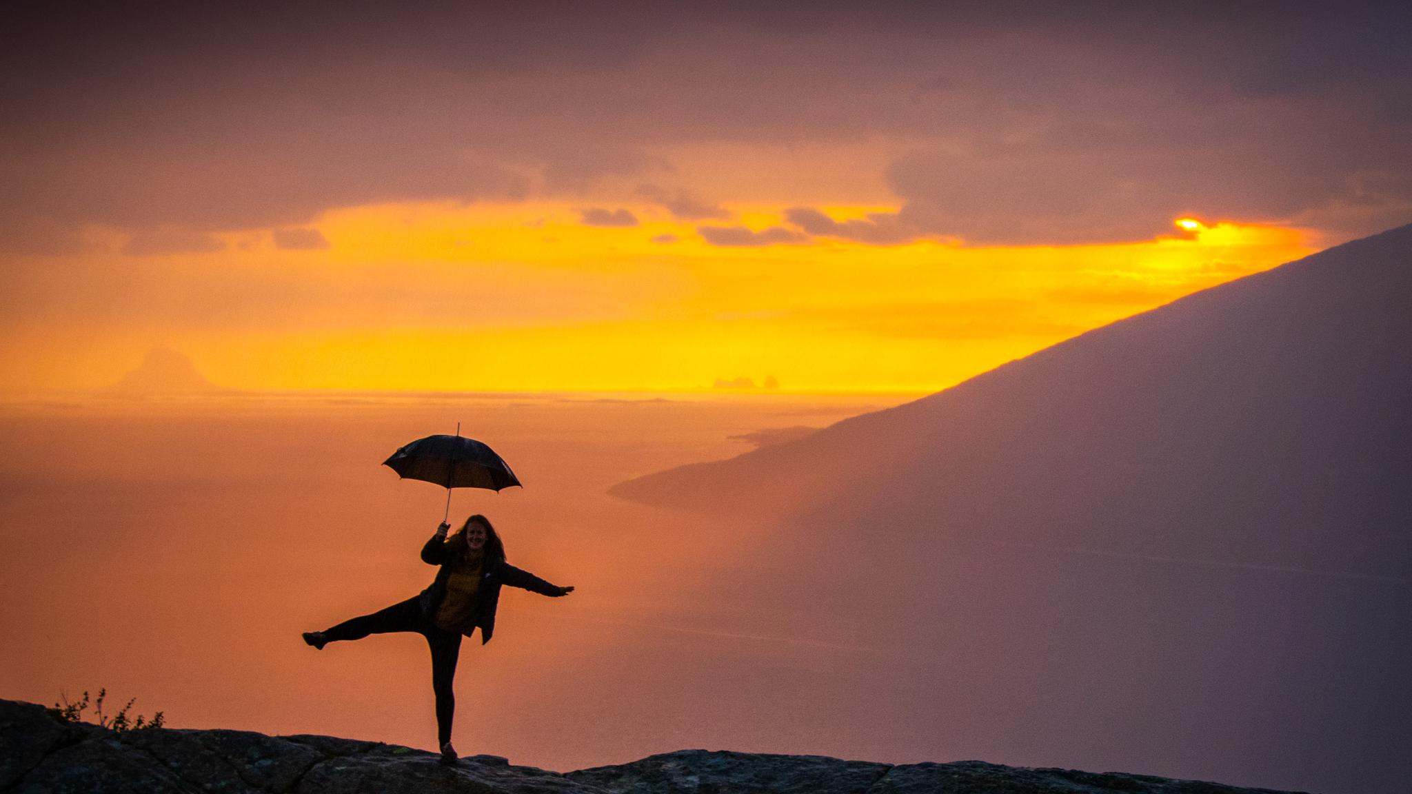 Girl holding an umbrella at the Sjonfjellet mountain in Northern Norway