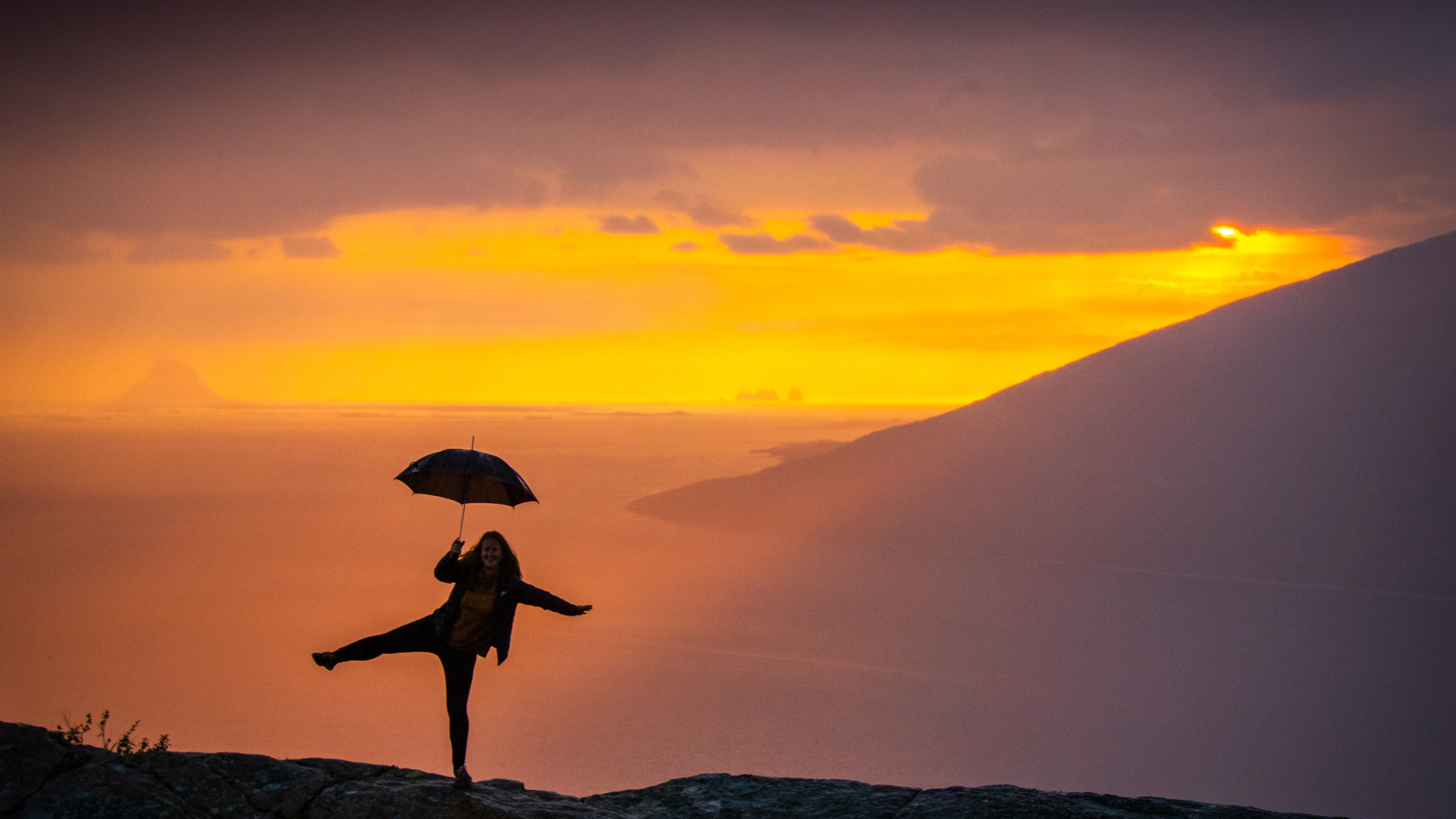 Girl holding an umbrella at the Sjonfjellet mountain in Northern Norway