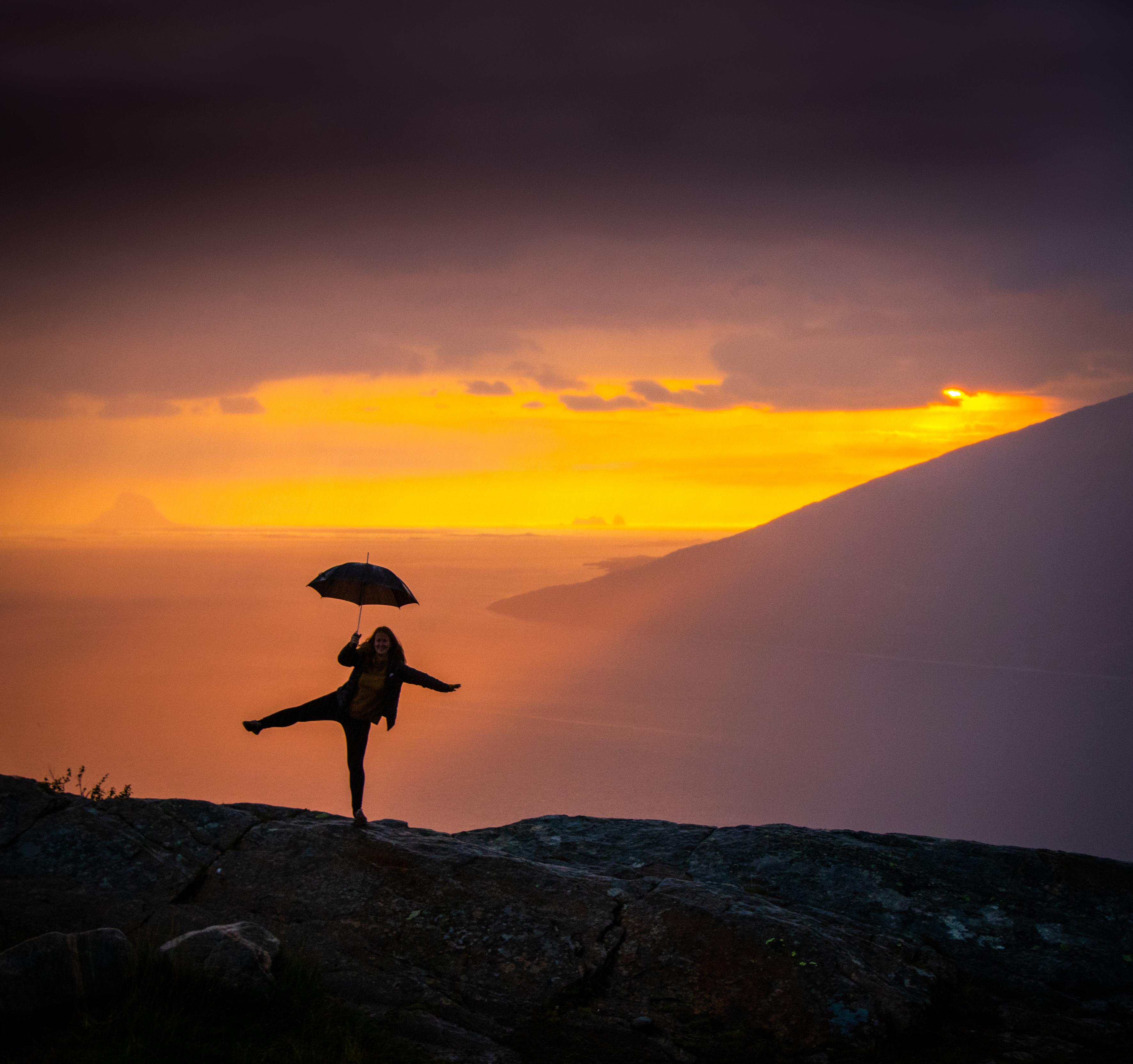 Girl holding an umbrella at the Sjonfjellet mountain in Northern Norway