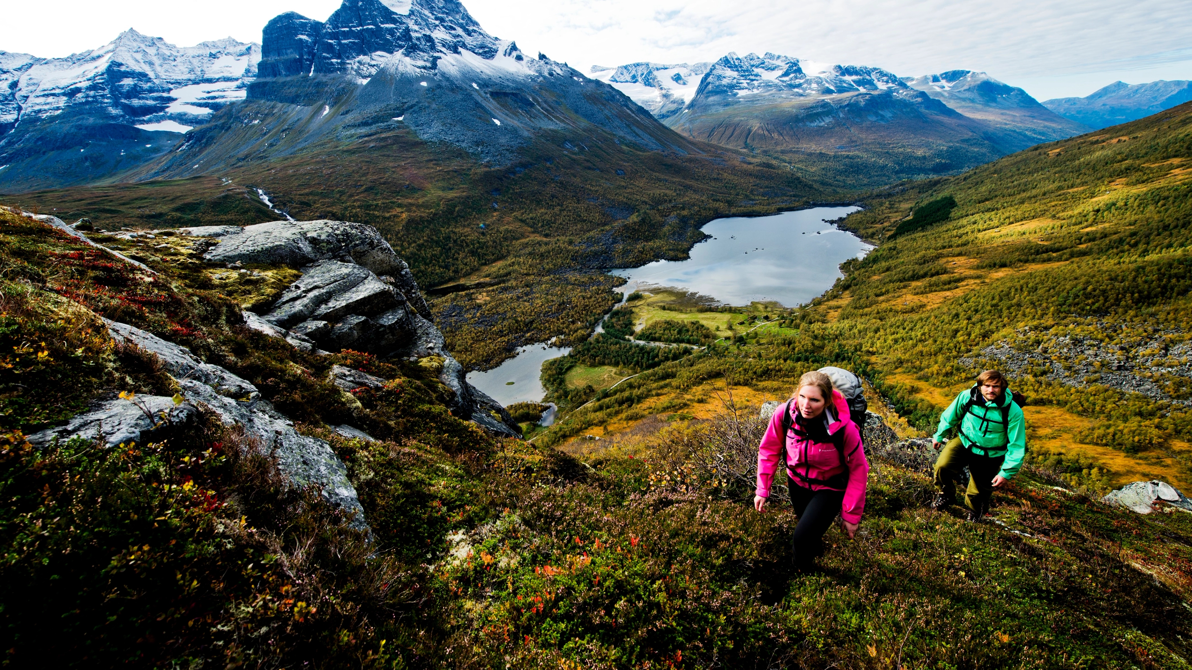 Two people hiking in the Innerdalen valley in Northwest, Fjord Norway
