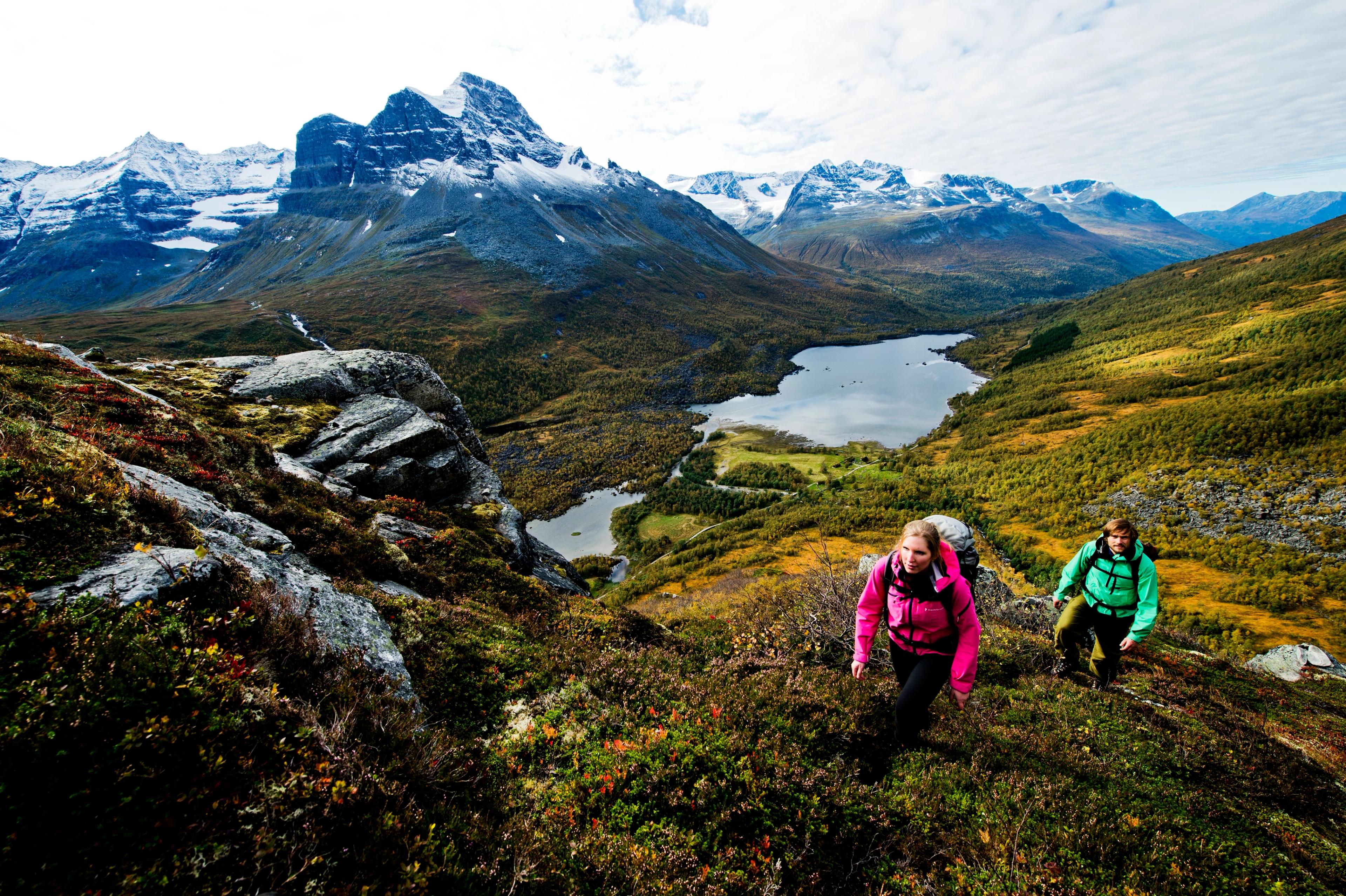 Two people hiking in the Innerdalen valley in Northwest, Fjord Norway