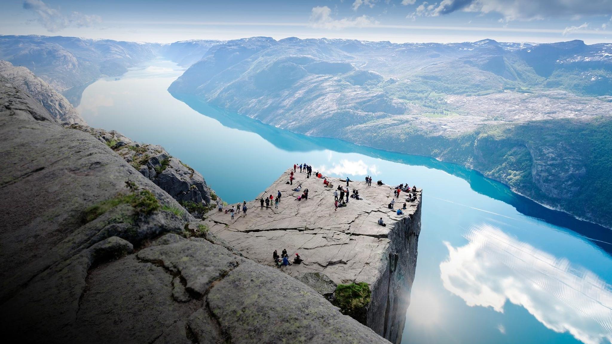 People standing on Preikestolen mountain in Lysefjorden in Fjord Norway