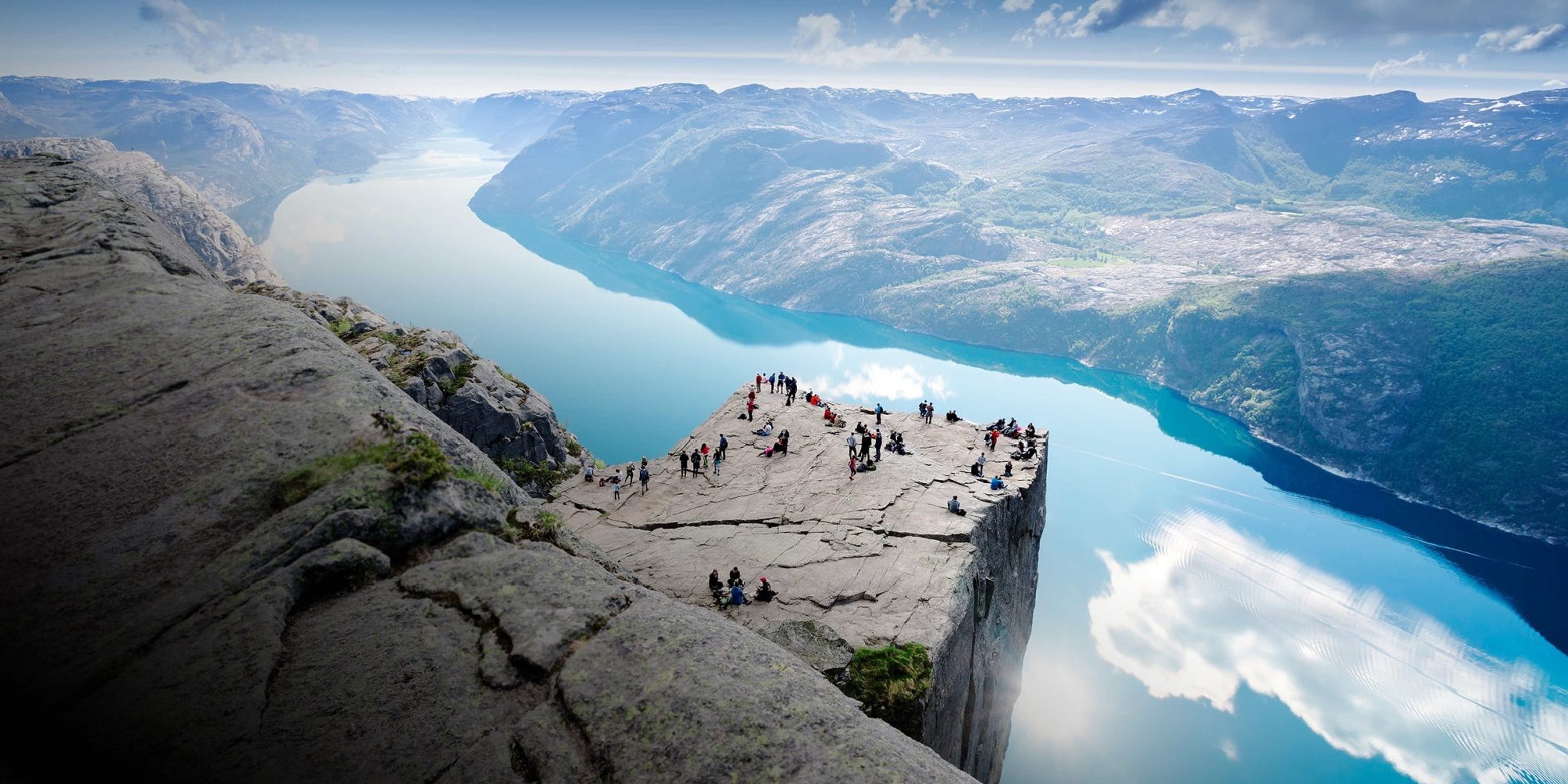 People standing on Preikestolen mountain in Lysefjorden in Fjord Norway