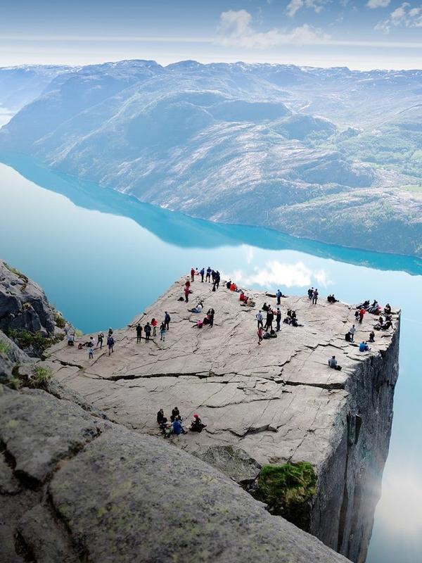 People standing on Preikestolen mountain in Lysefjorden in Fjord Norway