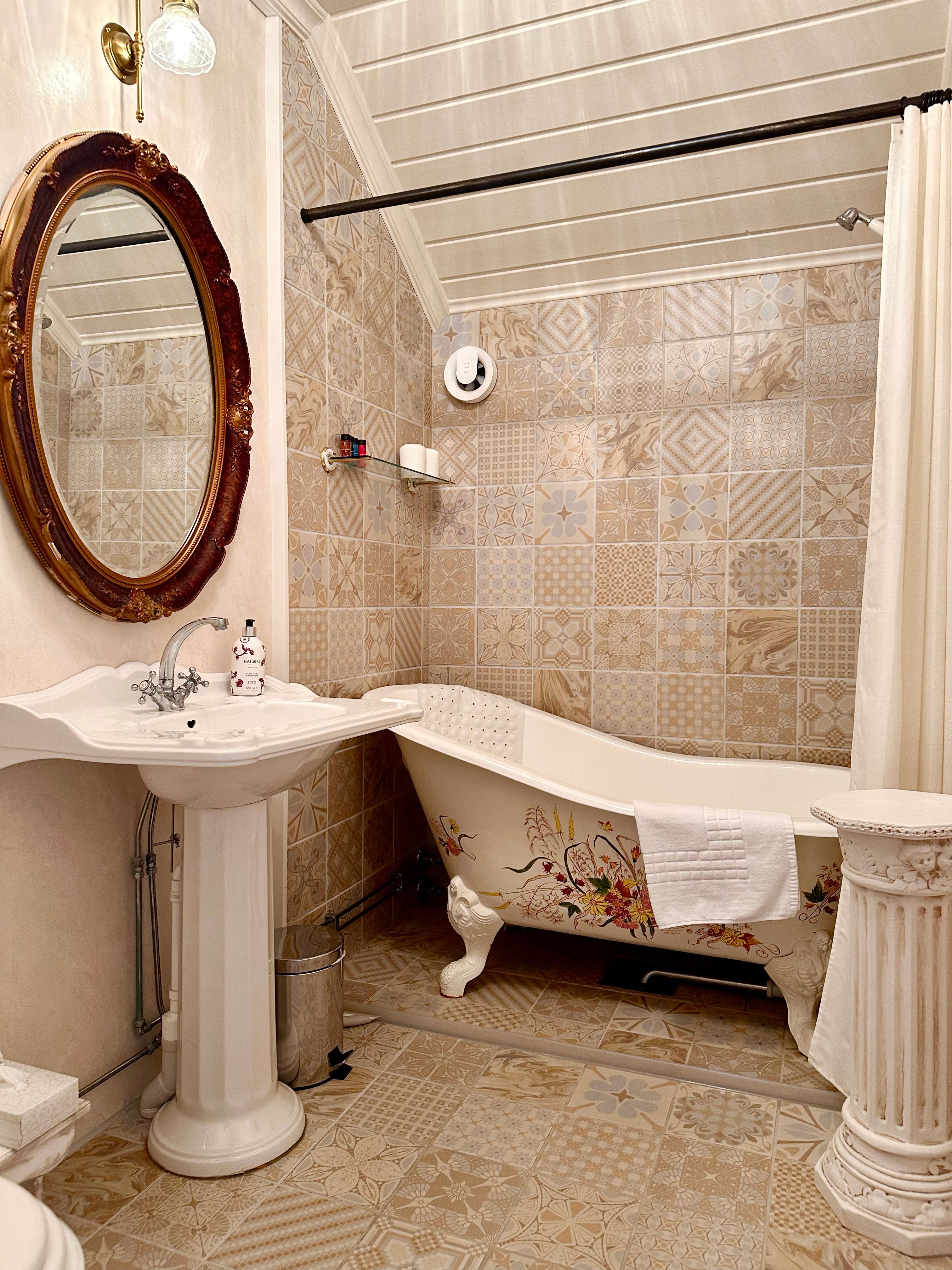 A bathtub in a nostalgic bathroom.