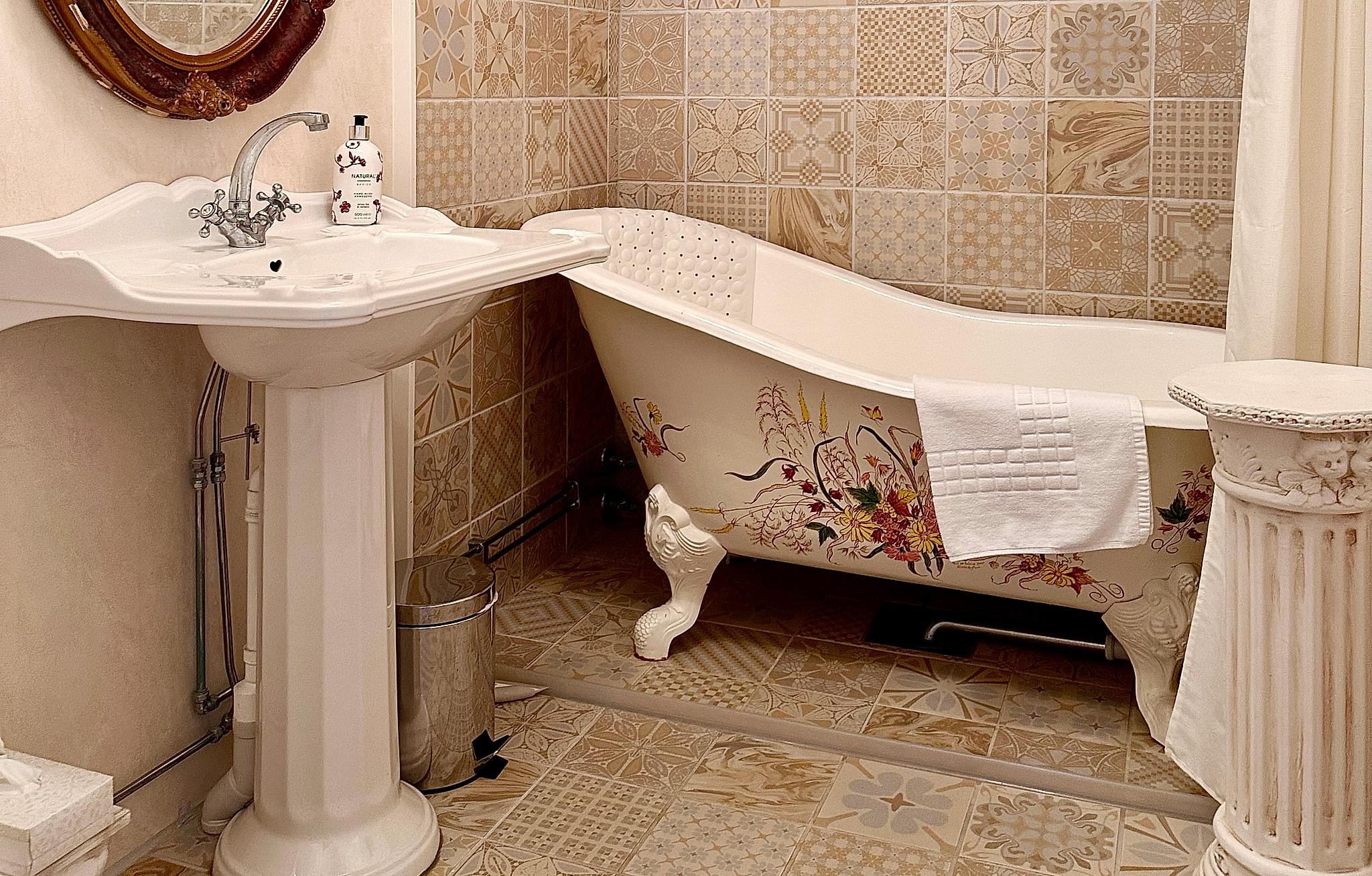 A bathtub in a nostalgic bathroom.