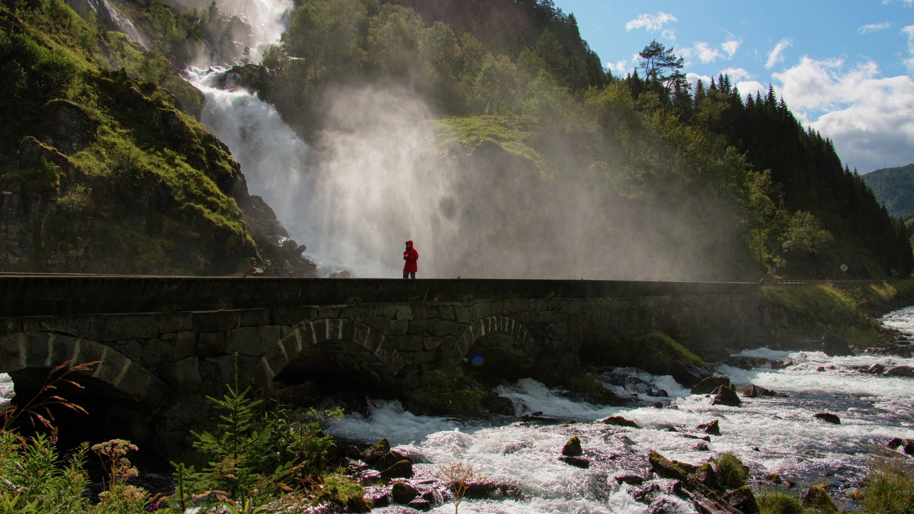 Someone walking by Låtefossen in Fjord Norway