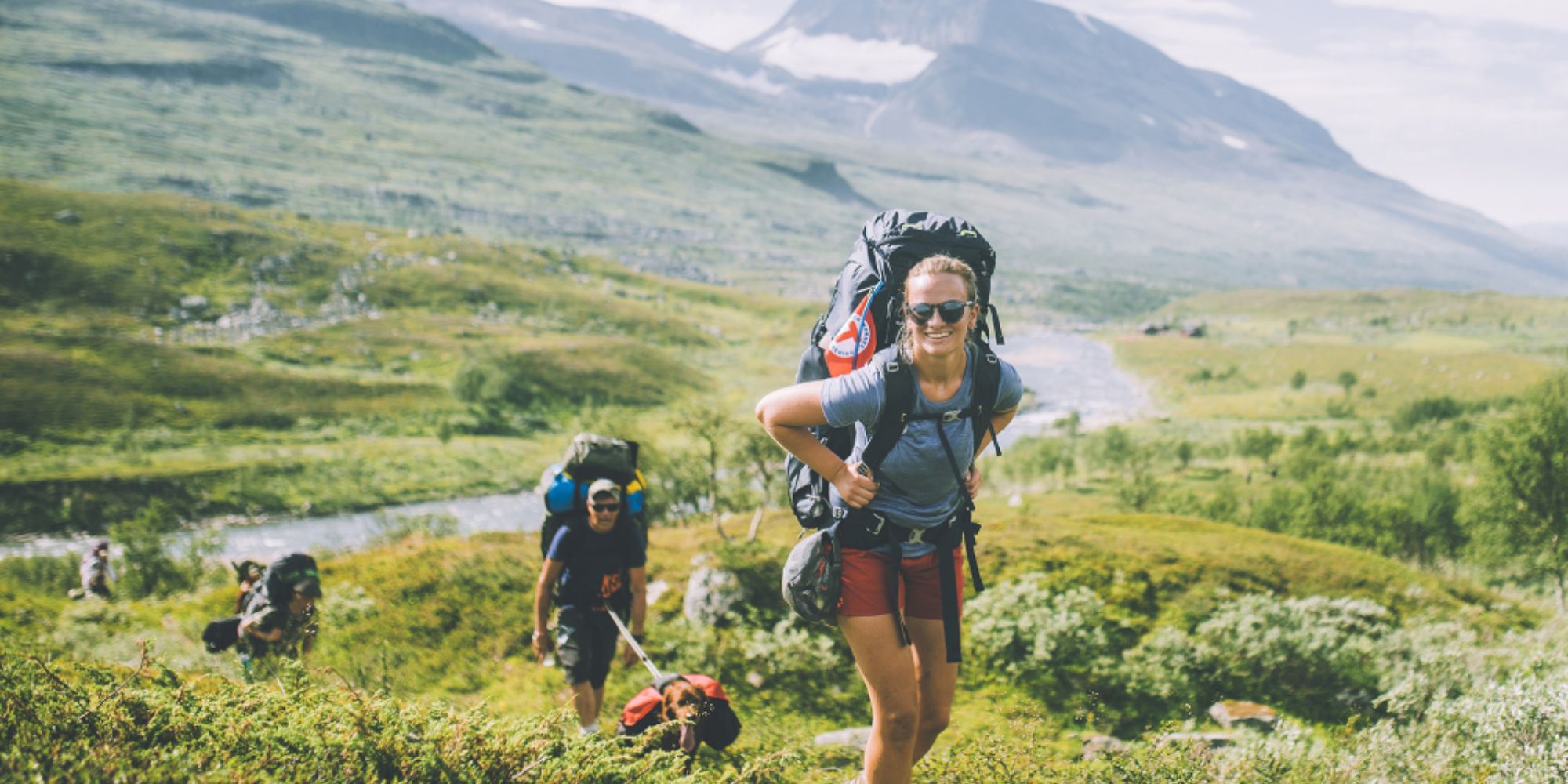 People summer hiking in mountainous landscape in Indre Troms, Northern Norway