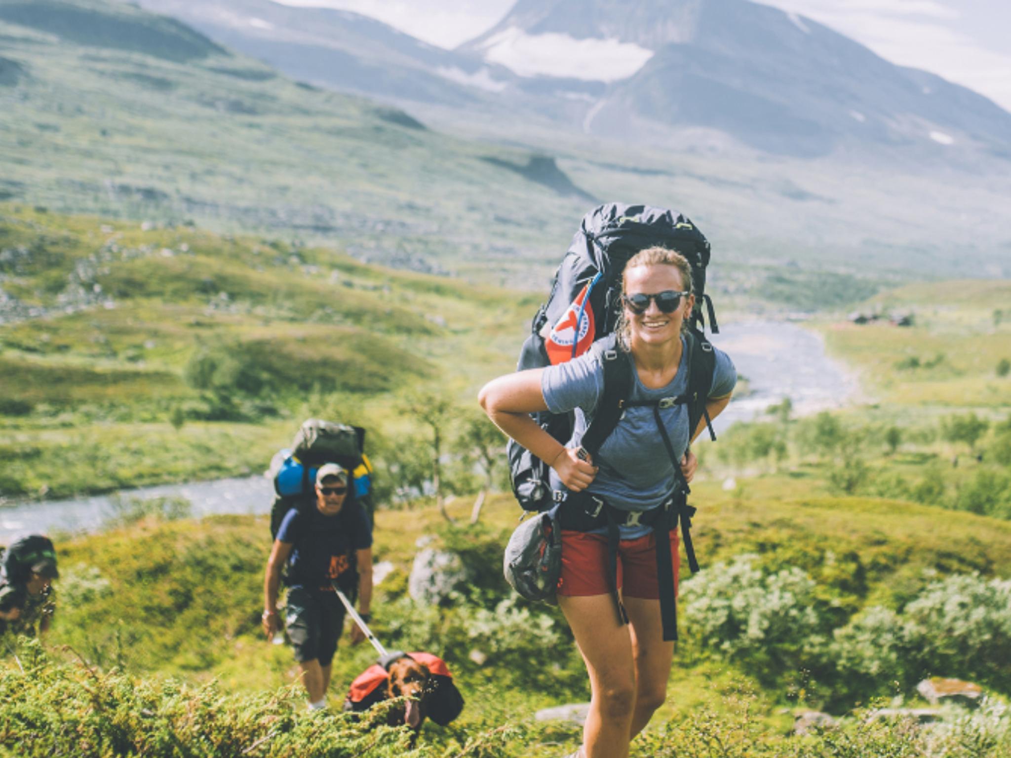 People summer hiking in mountainous landscape in Indre Troms, Northern Norway