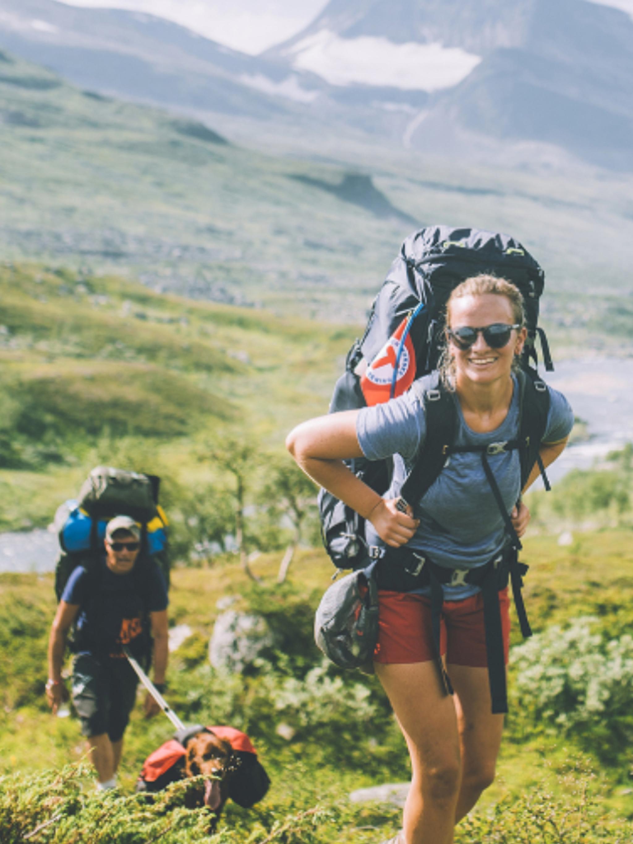 People summer hiking in mountainous landscape in Indre Troms, Northern Norway