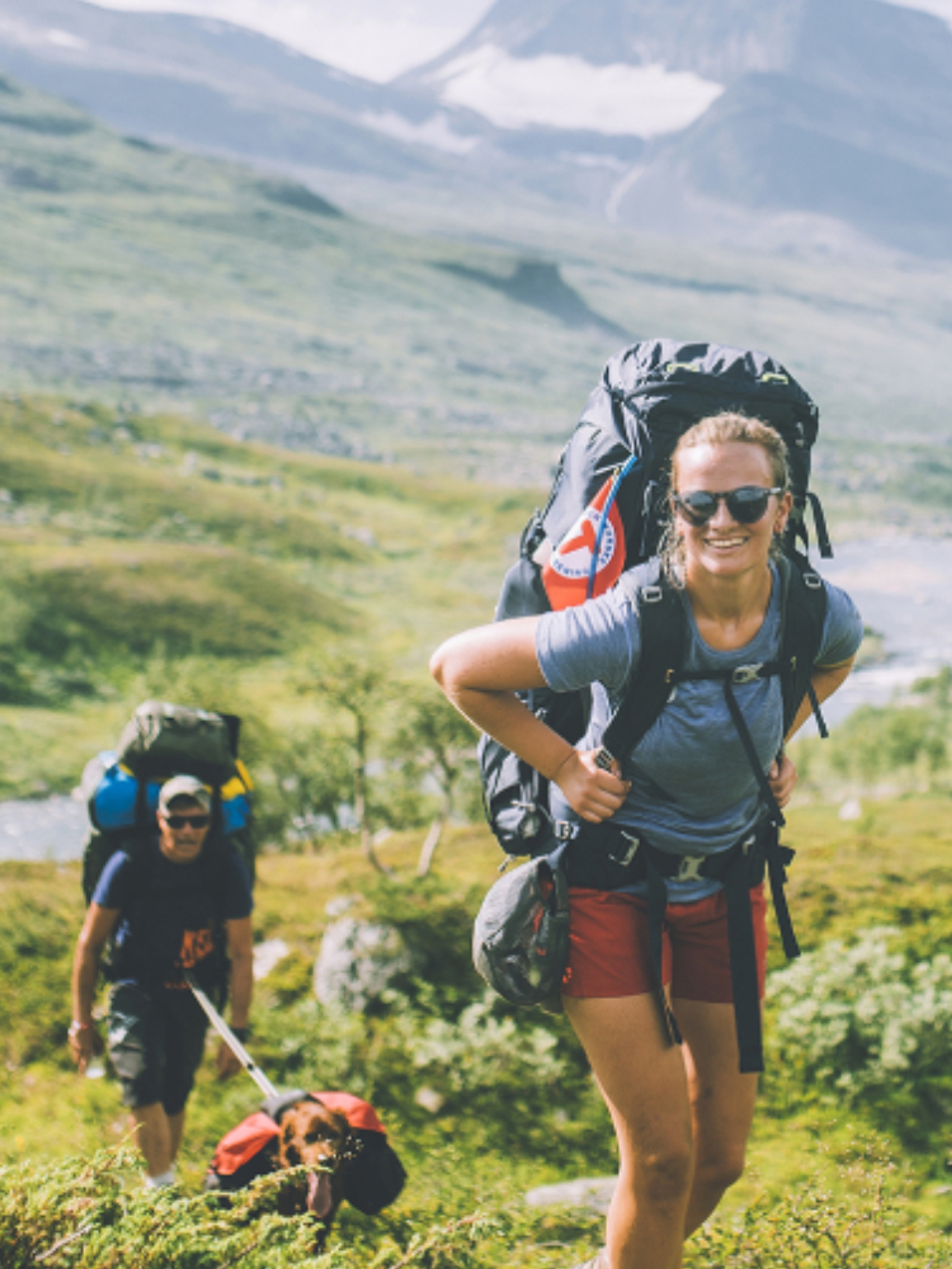 People summer hiking in mountainous landscape in Indre Troms, Northern Norway