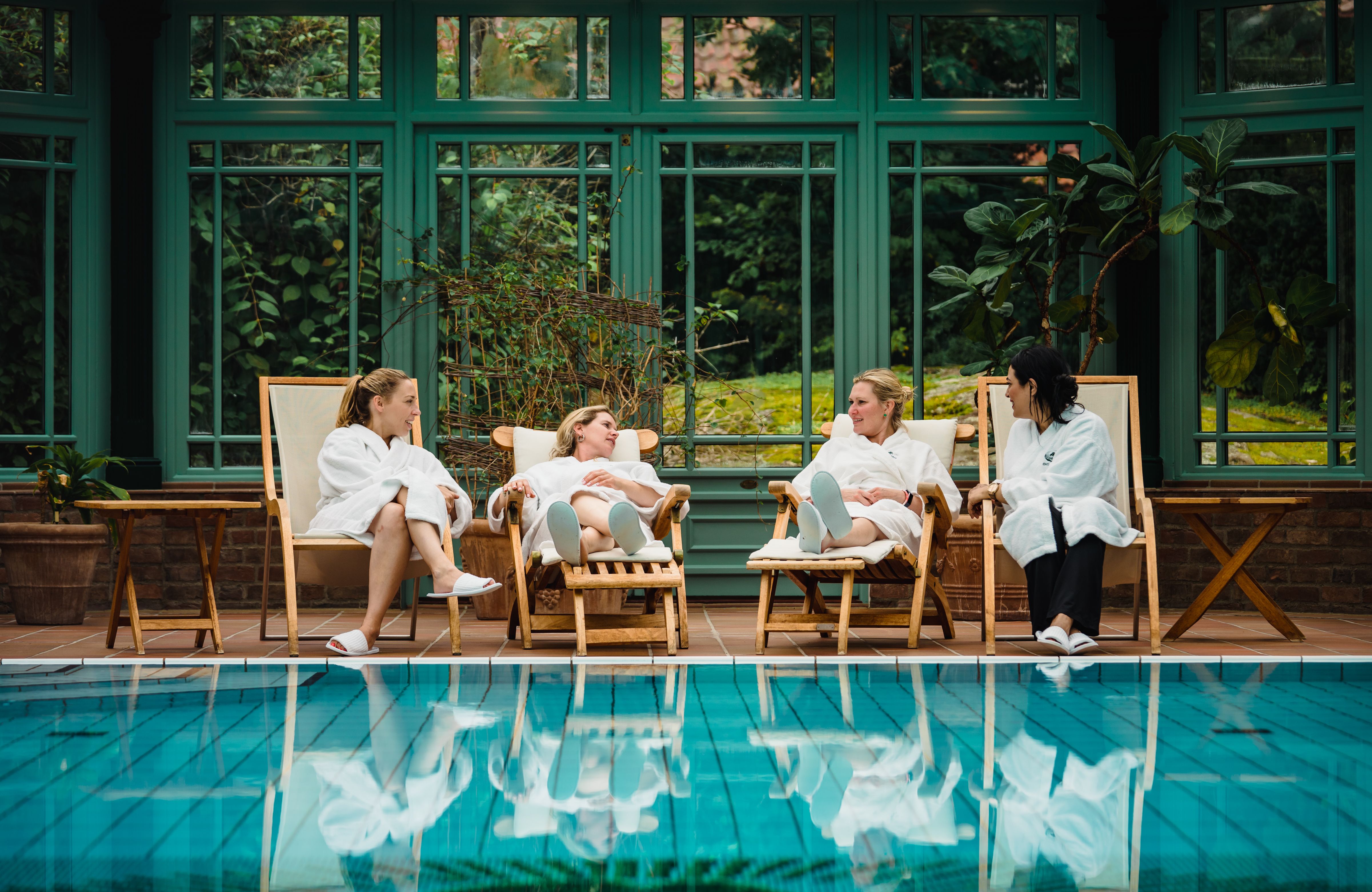 Four women relaxing by the indoor pool at Engø gård at Tjøme, Eastern Norway