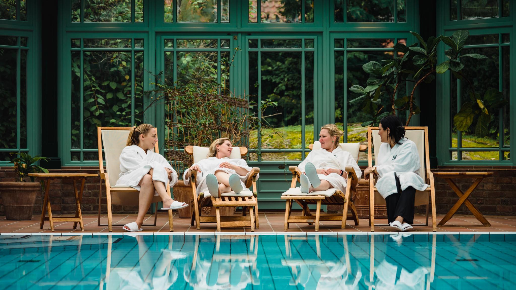 Four women relaxing by the indoor pool at Engø gård at Tjøme, Eastern Norway