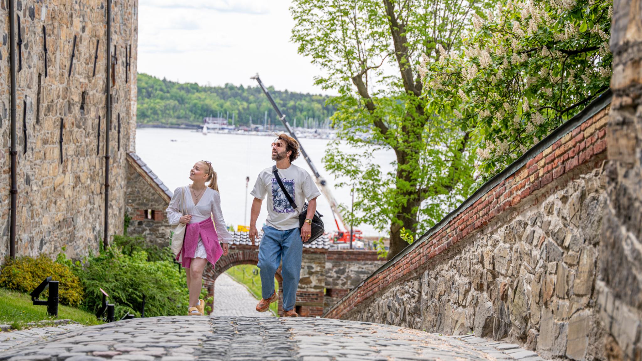 Two people sightseeing at Akershus Fortress in Oslo