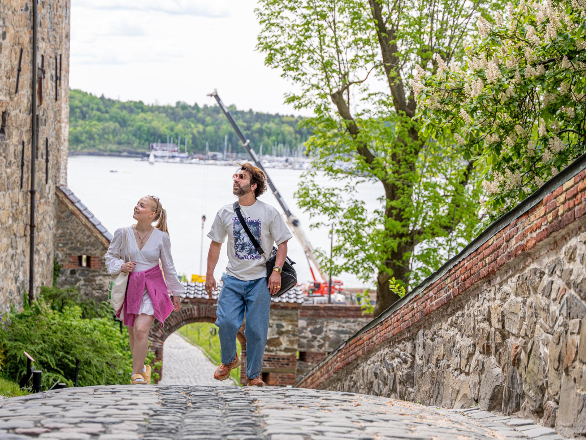 Two people sightseeing at Akershus Fortress in Oslo