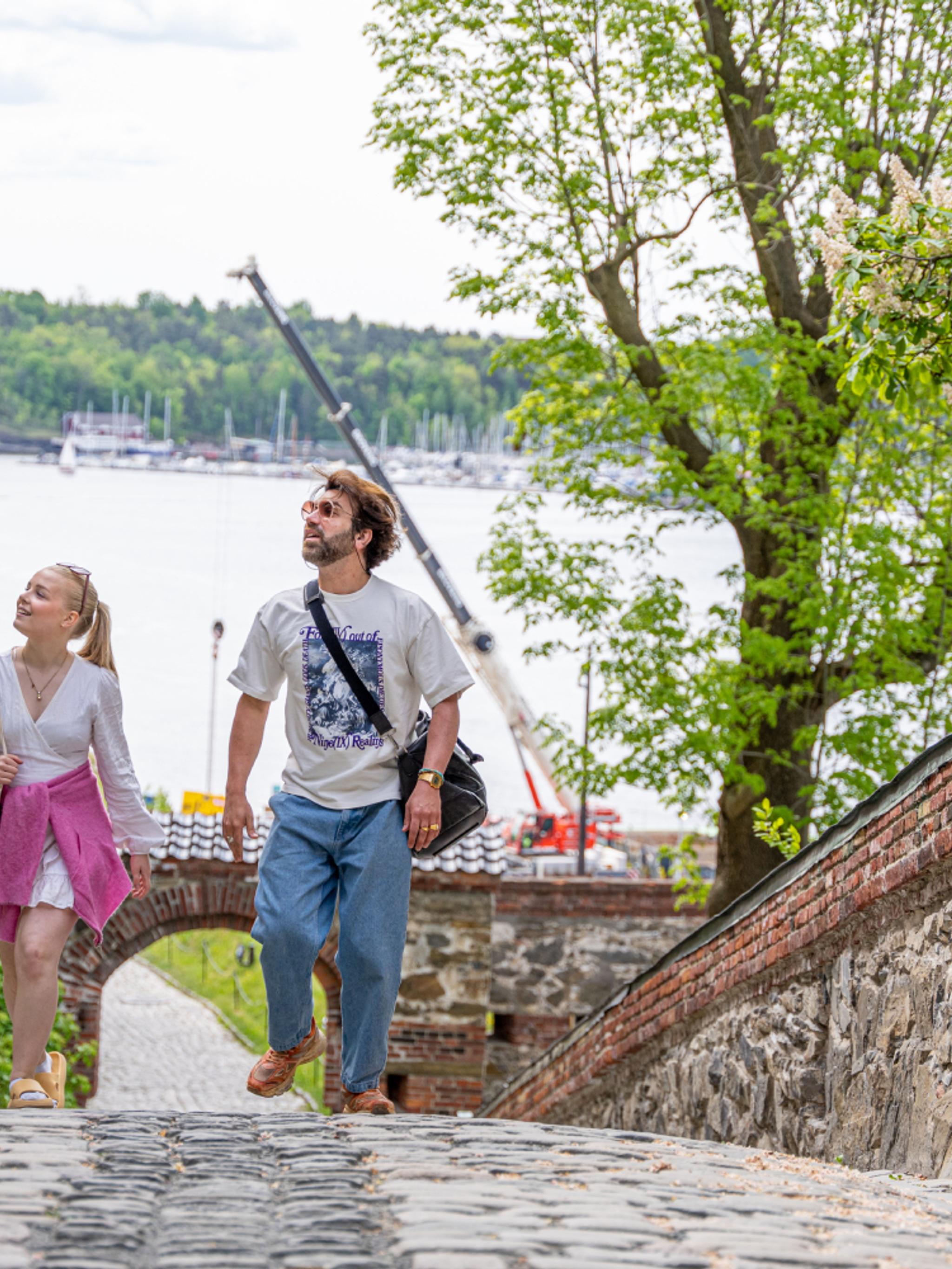 Two people sightseeing at Akershus Fortress in Oslo