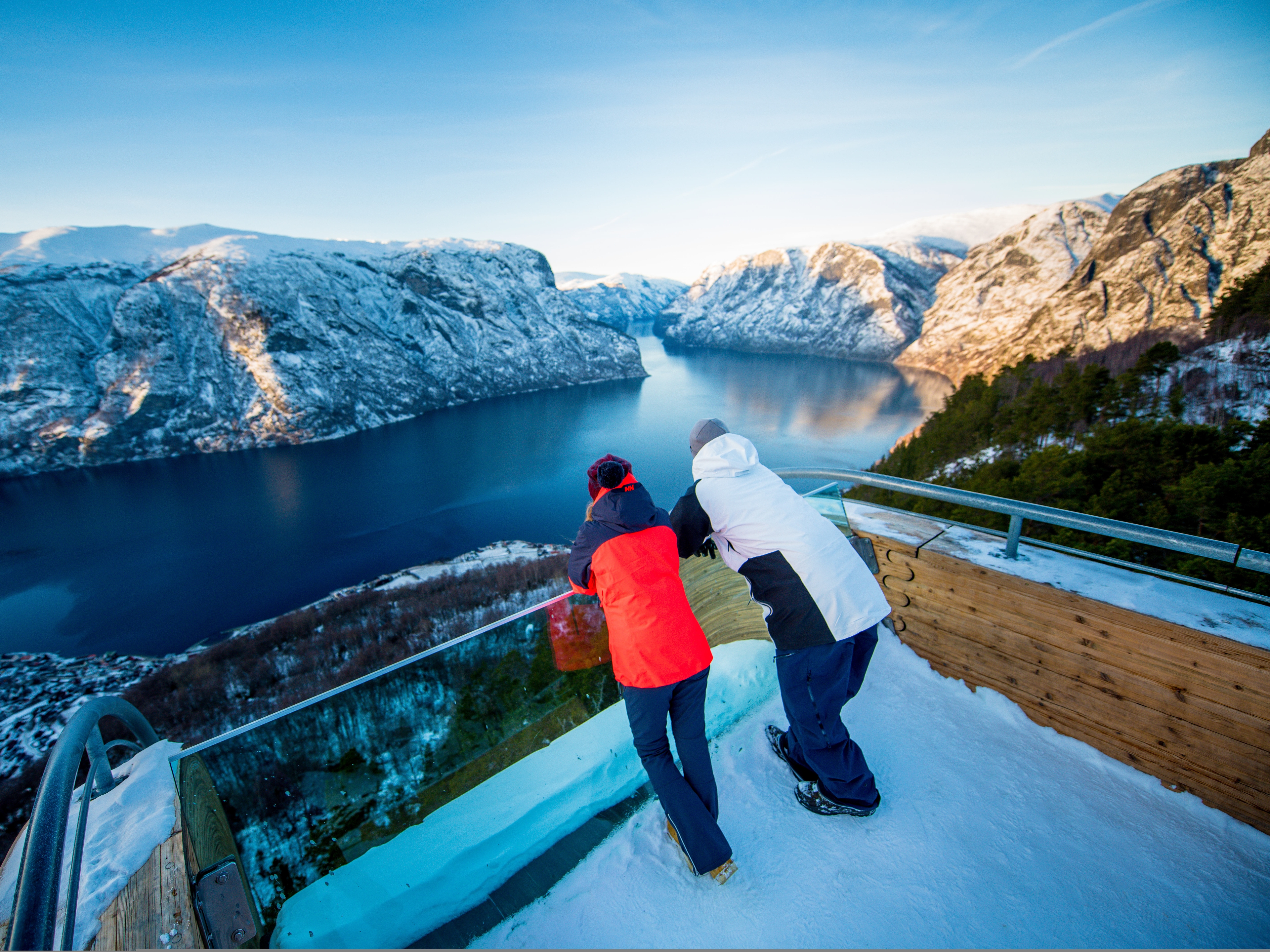 People admiring the view of the Aurlandsfjord from Stegastein viewpoint on Norwegian Scenic Route Aurlandsfjellet in Fjord Norway in winter