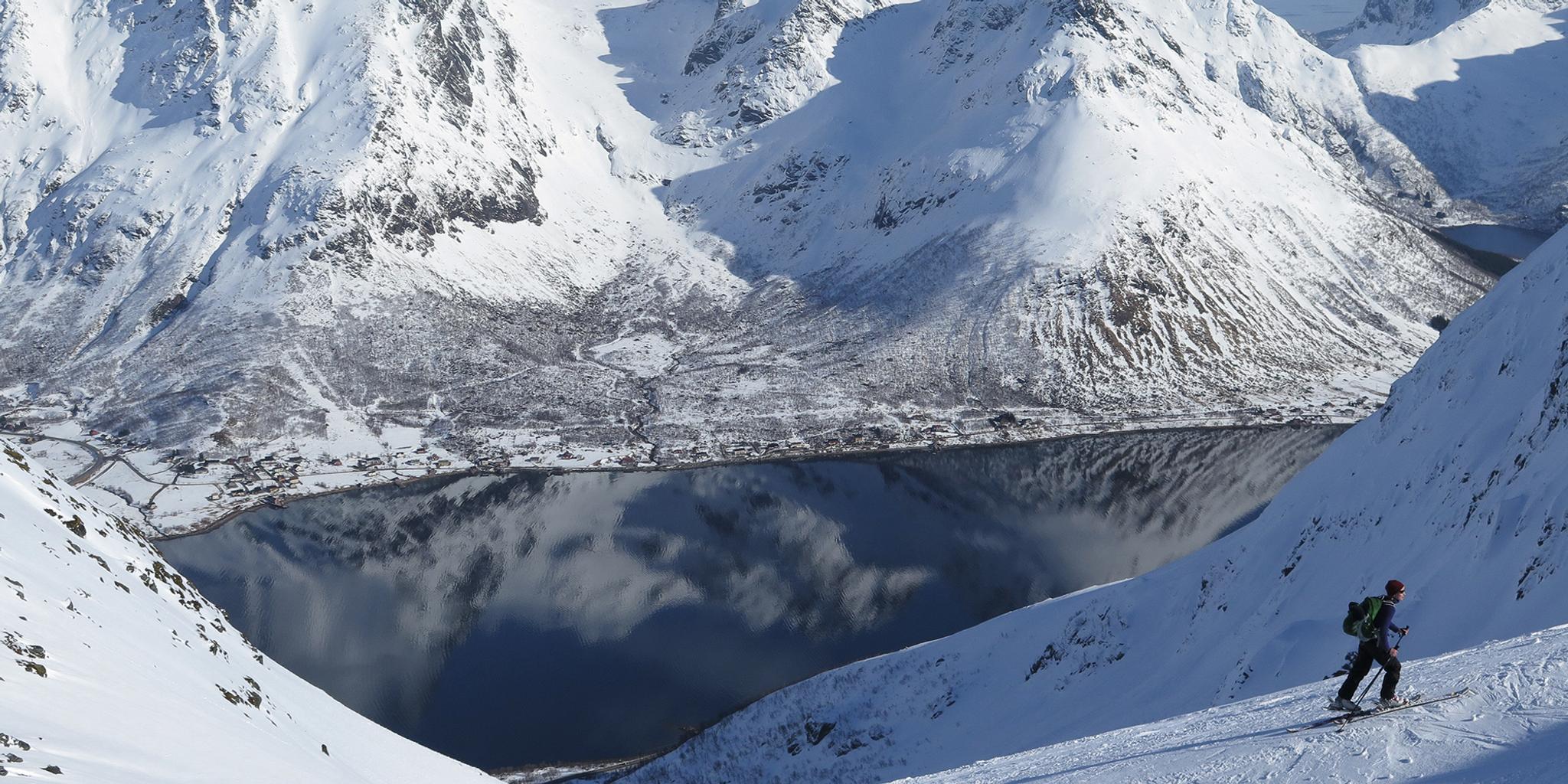 A ski tourer on his way up Mount Kvittinden in Lofoten, Norway