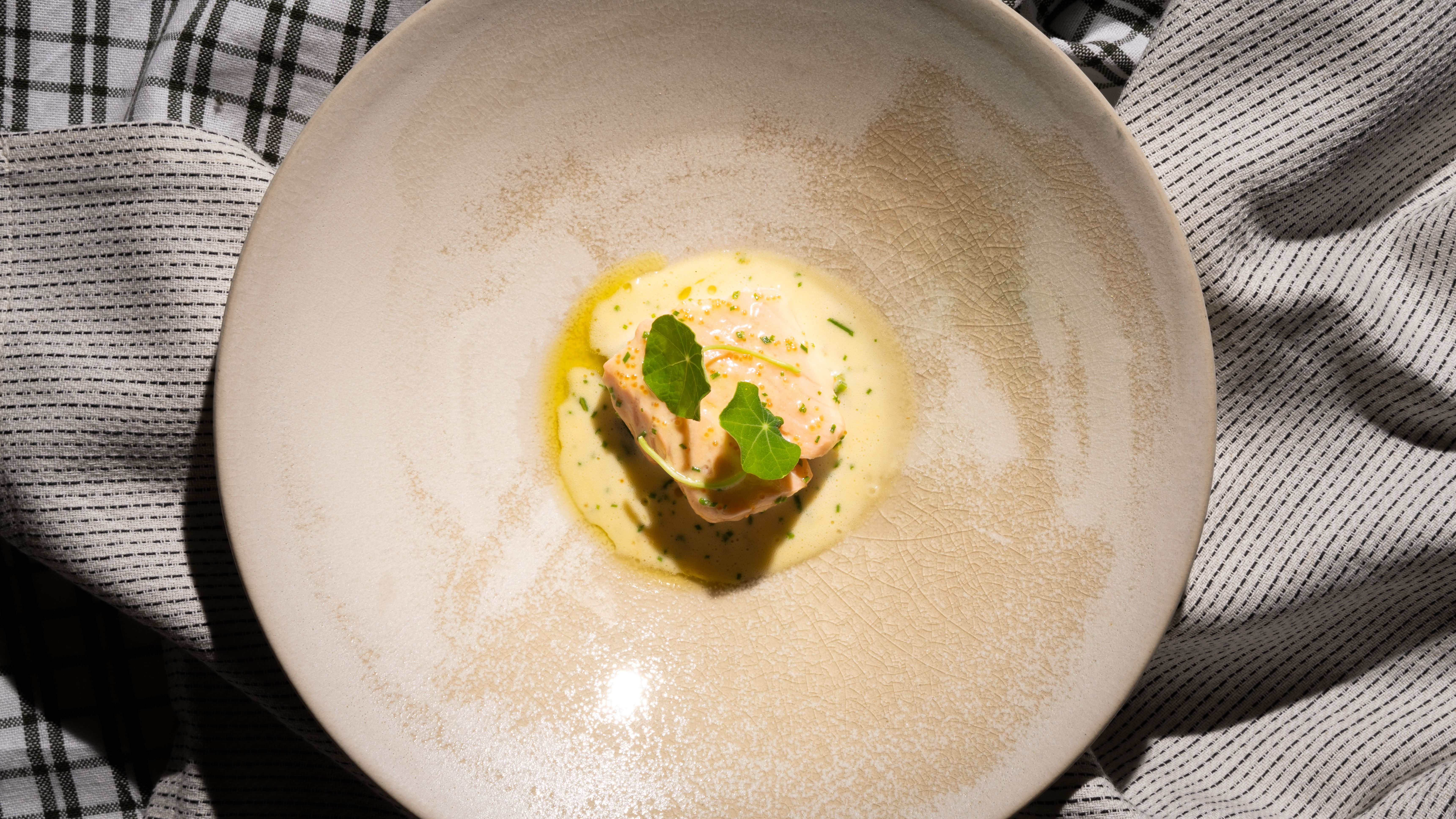 A plate with traditional baked salmon with Sandefjord butter made by star chef Tom Victor Gausdal.