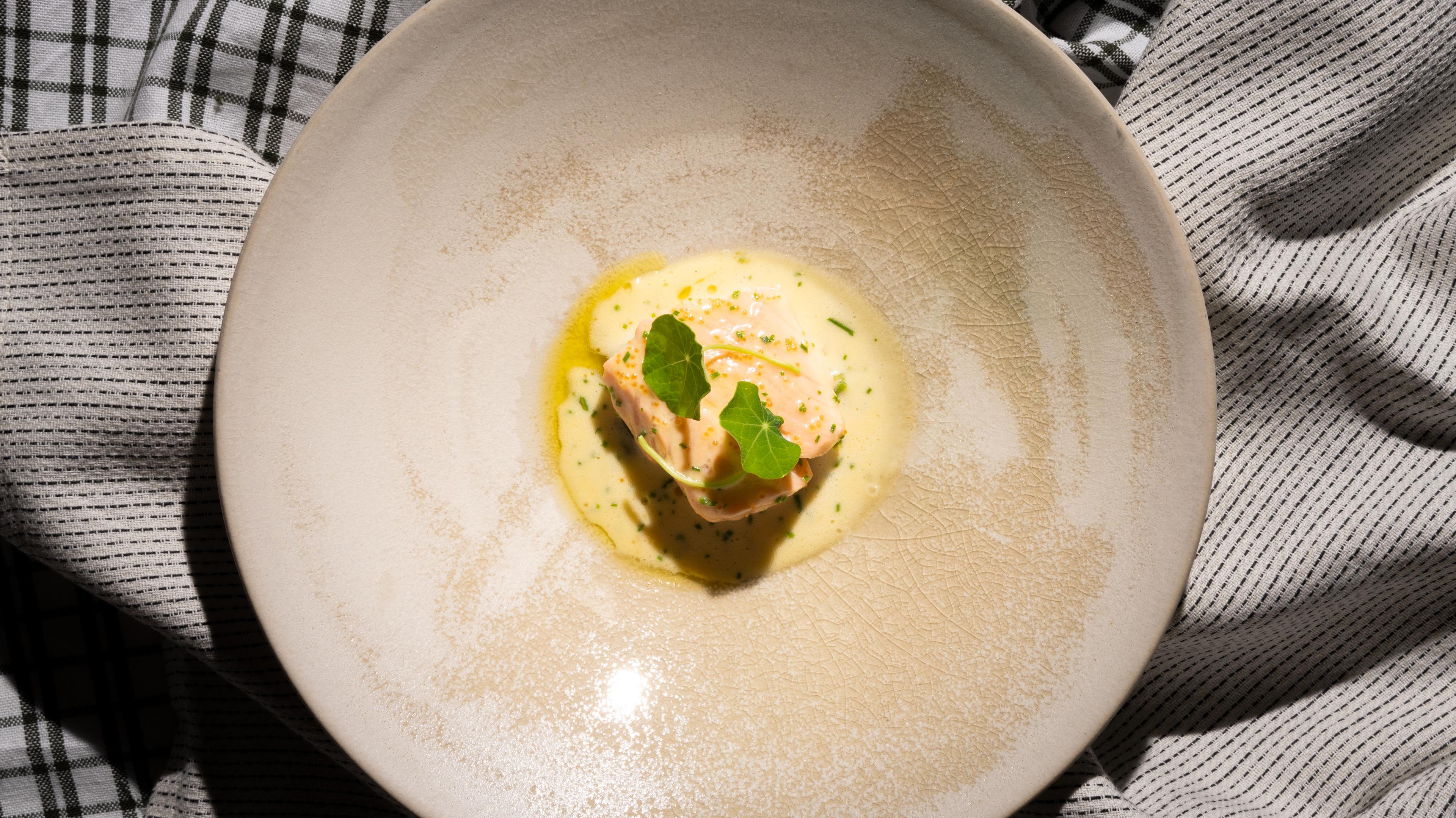 A plate with traditional baked salmon with Sandefjord butter made by star chef Tom Victor Gausdal.
