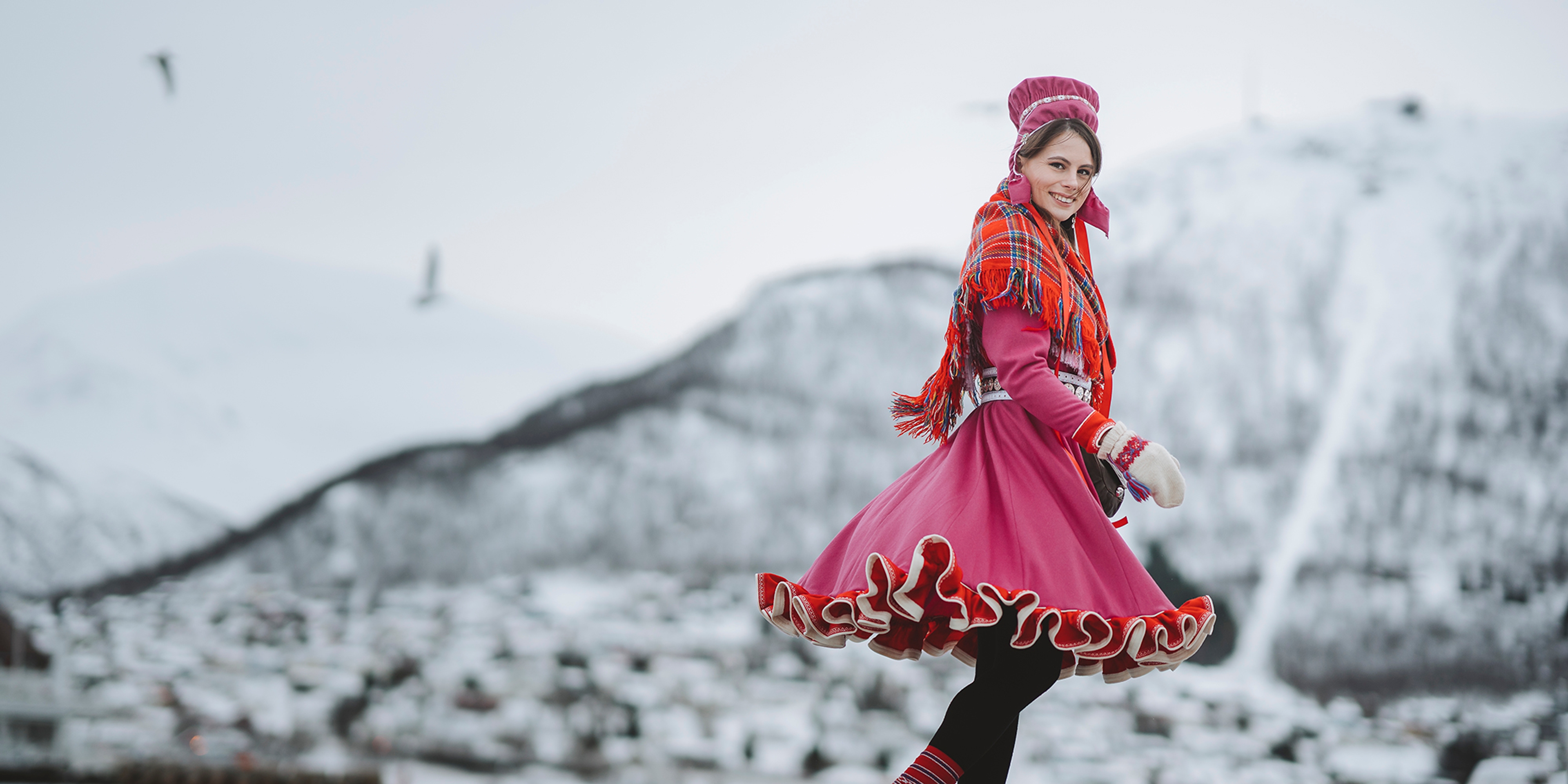 A woman is wearing traditional sami clothing in Tromsø, Northern Norway