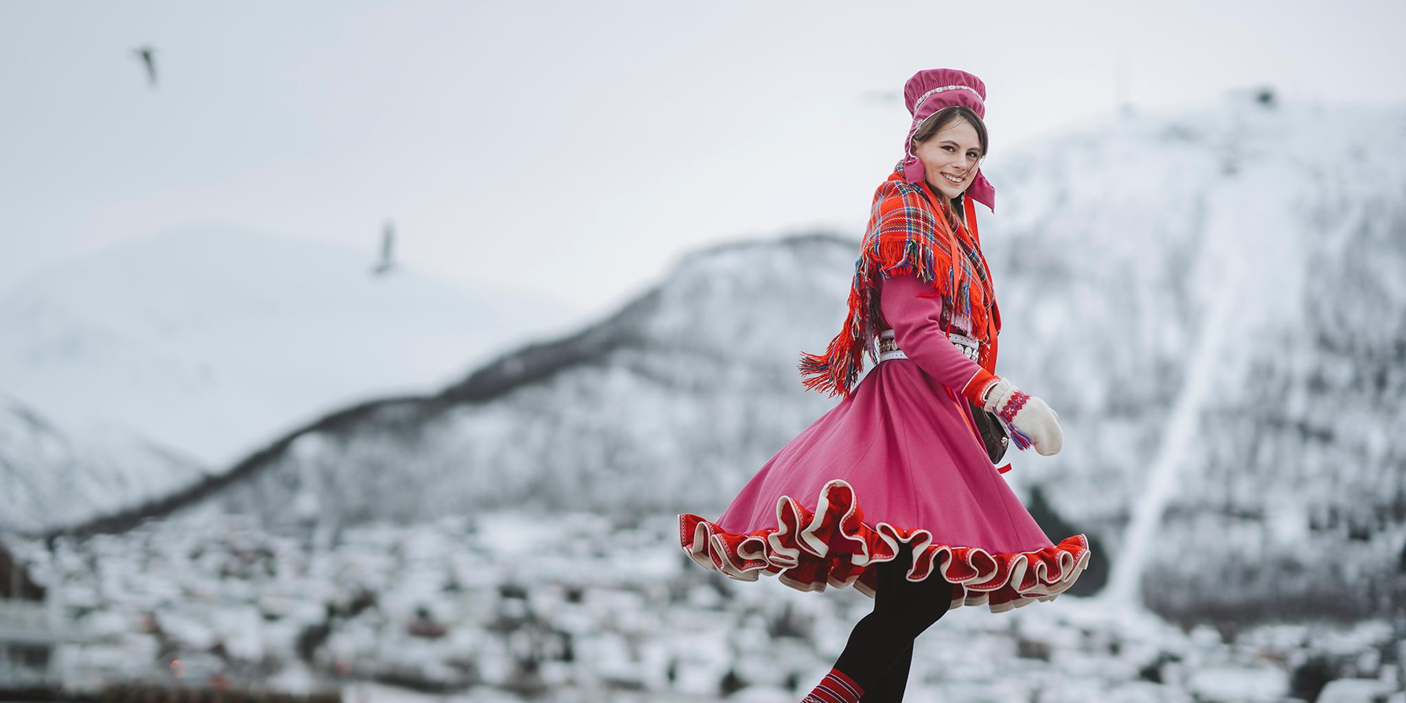 A woman is wearing traditional sami clothing in Tromsø, Northern Norway