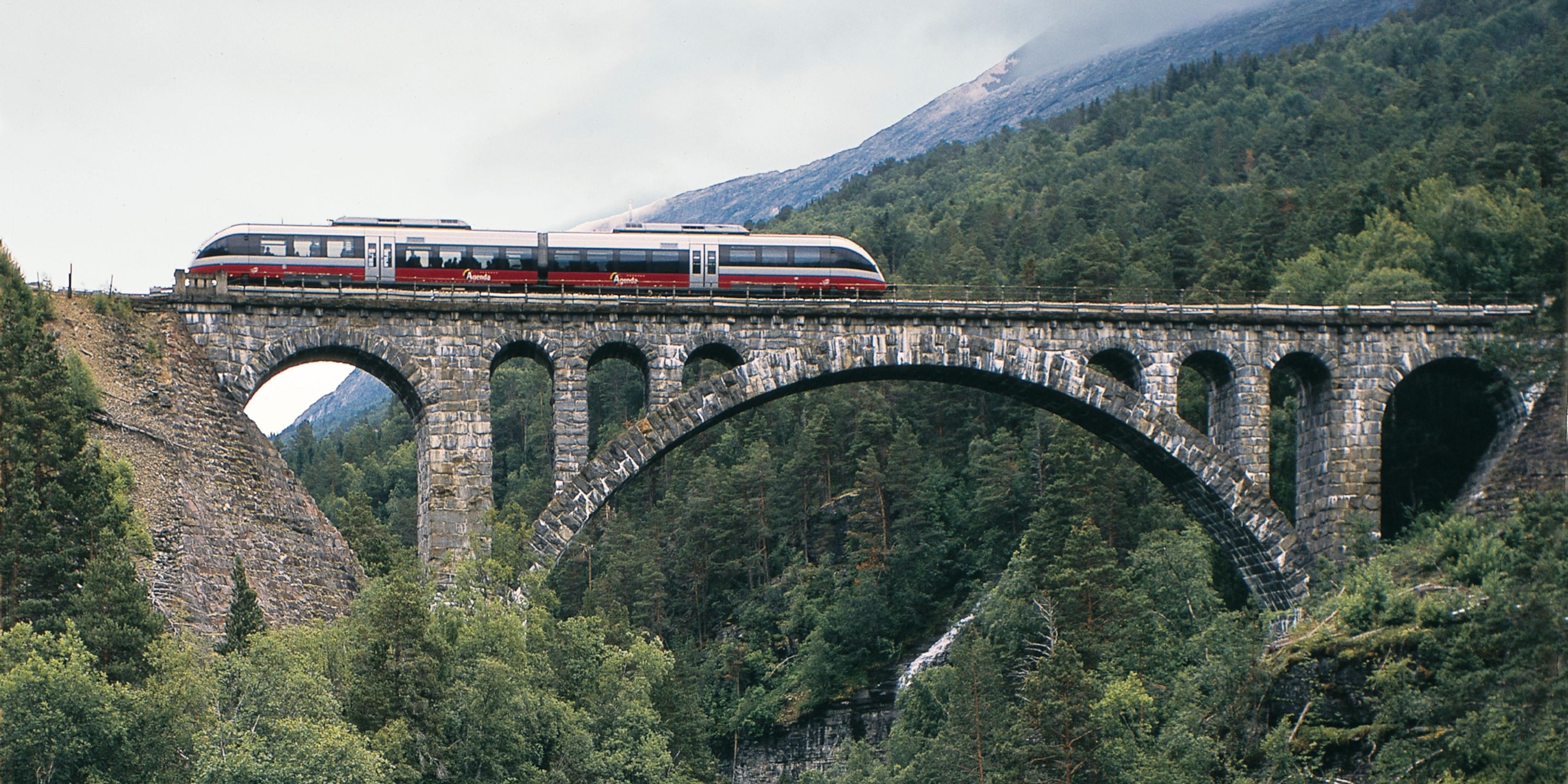 The Rauma Railway is one of the world’s best train journeys. Train crossing Kylling bridge in Rauma, Fjord Norway.