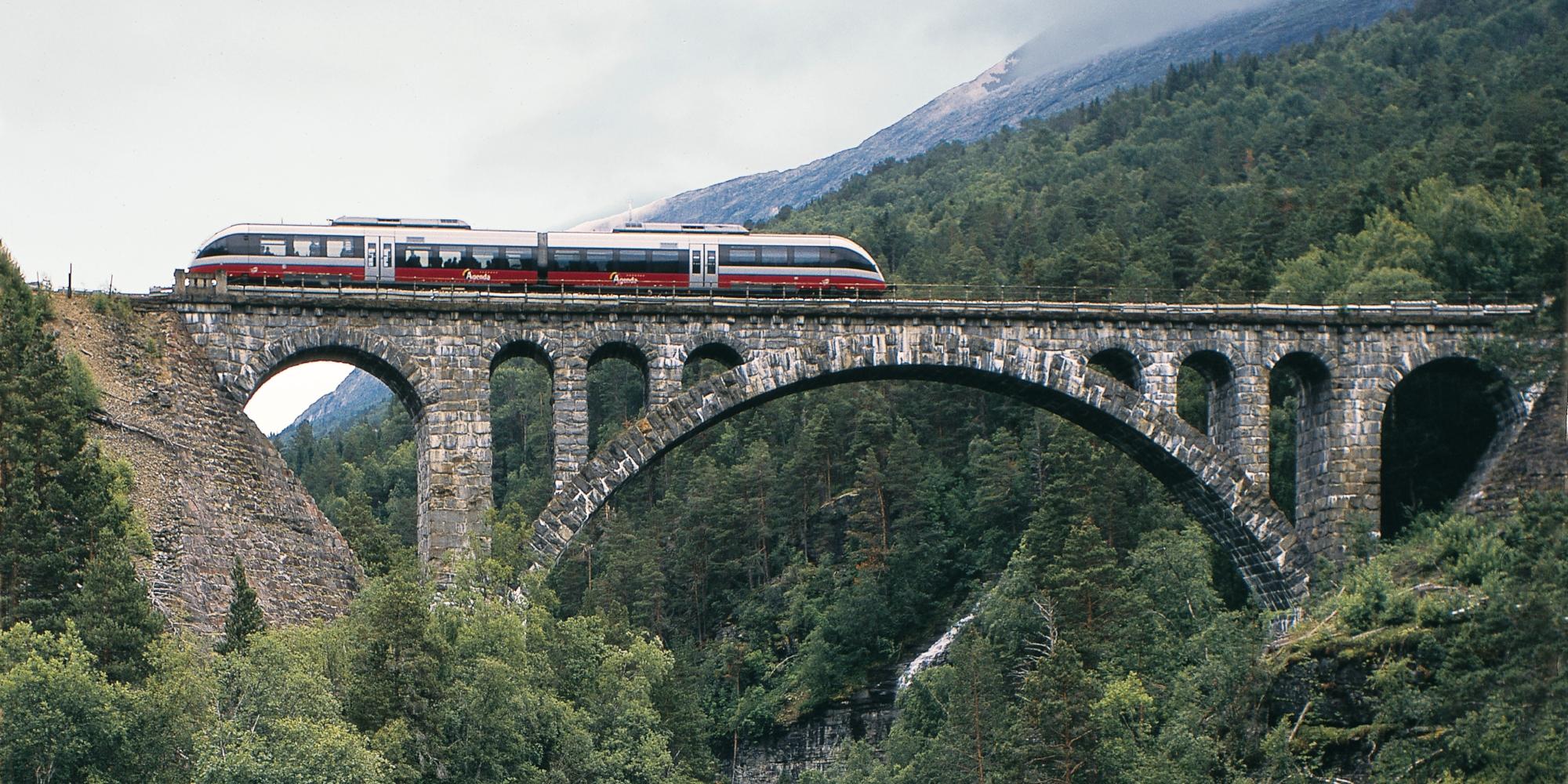 The Rauma Railway is one of the world’s best train journeys. Train crossing Kylling bridge in Rauma, Fjord Norway.