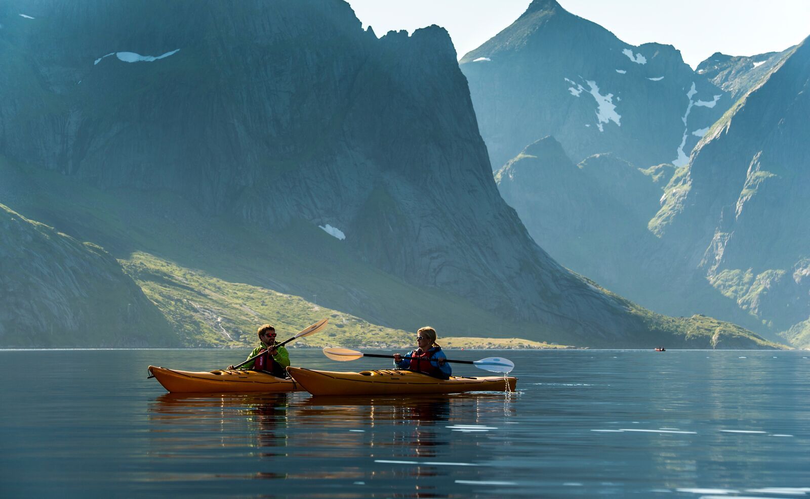 Couple kayaking in Reinefjorden, the Lofoten Islands