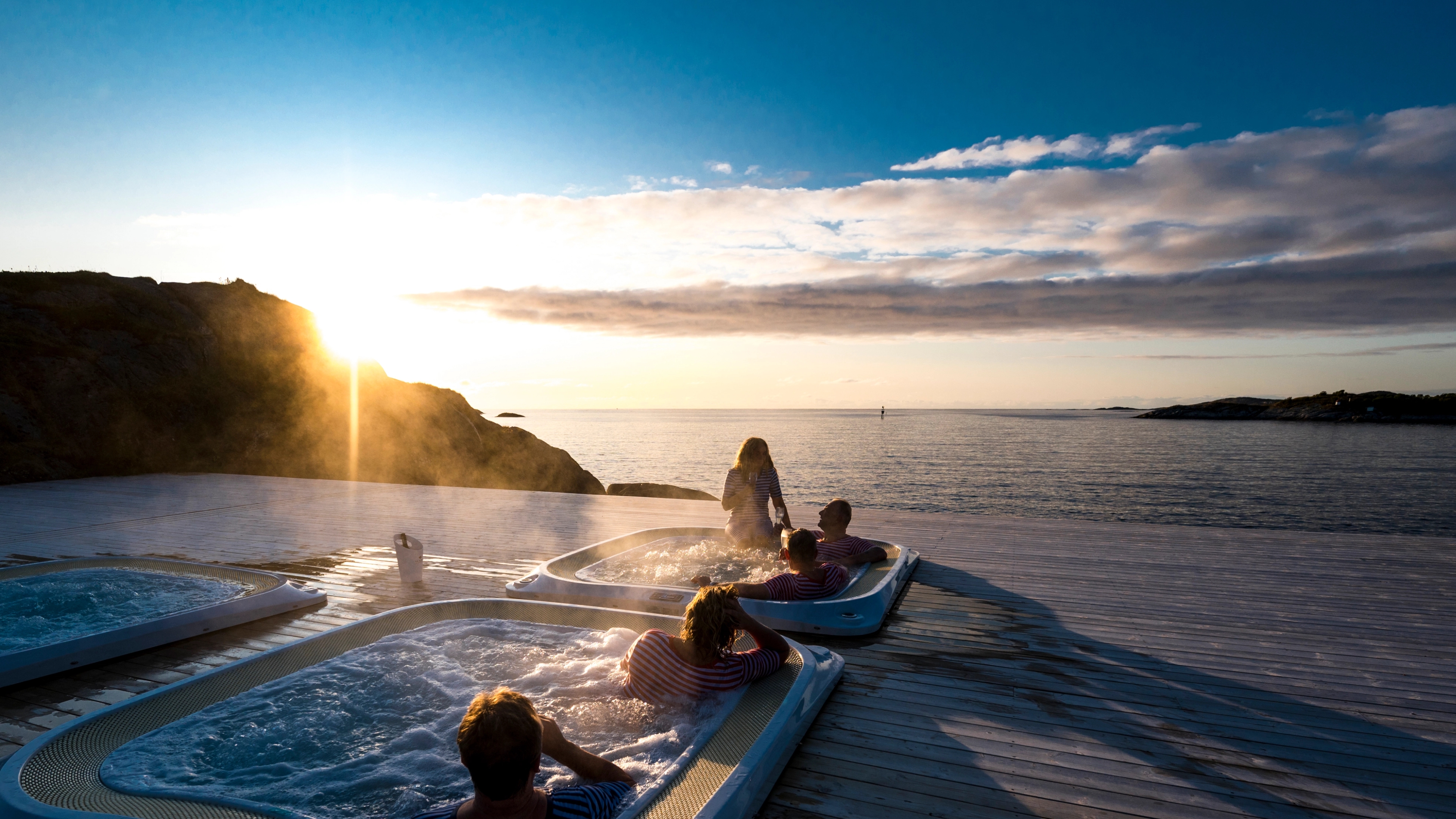 A group of people relaxing in the hot tubs in Hamn in Senja