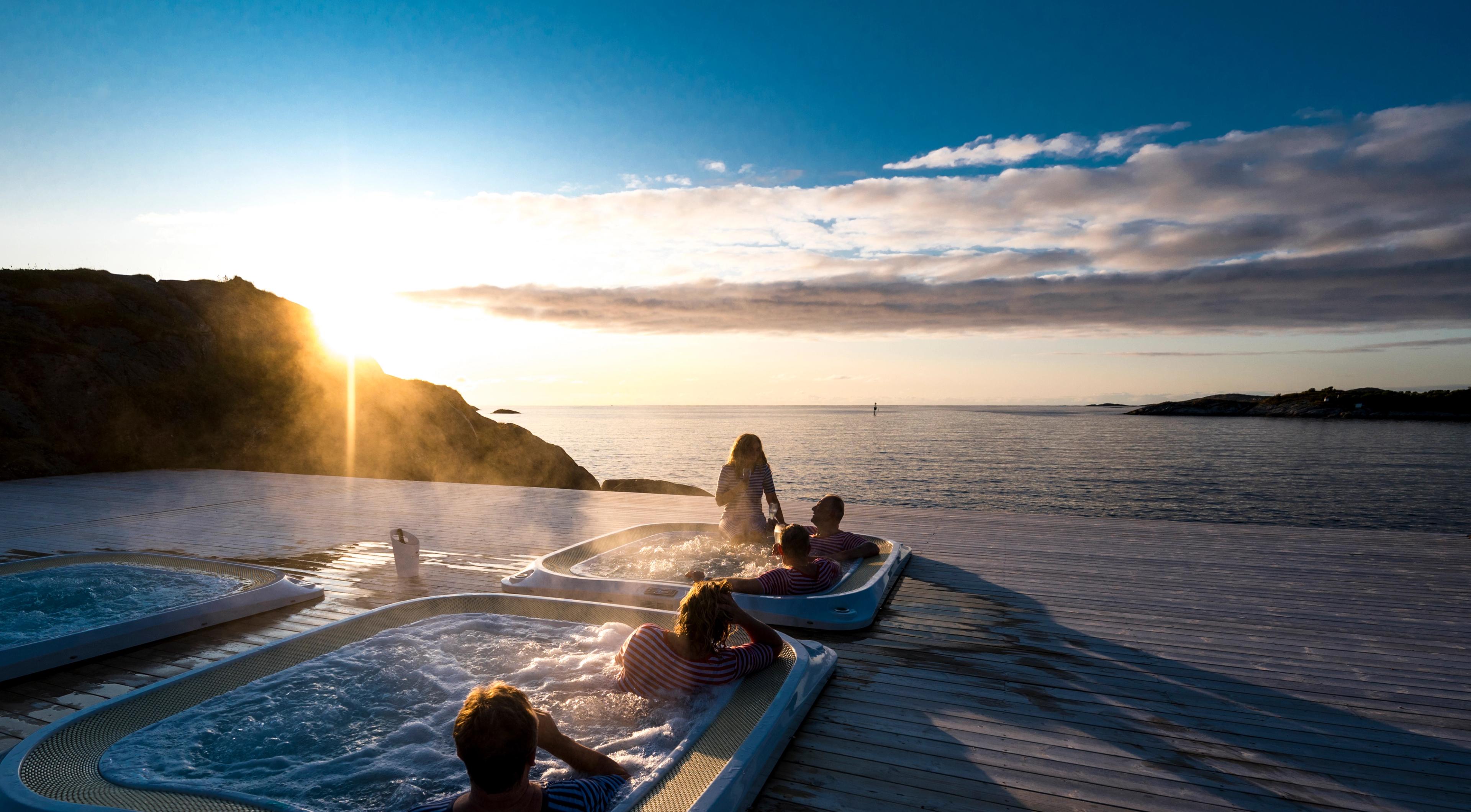 A group of people relaxing in the hot tubs in Hamn in Senja