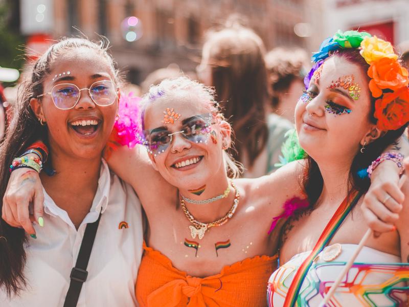 Three girls smiling in the Oslo Pride parade, 2023