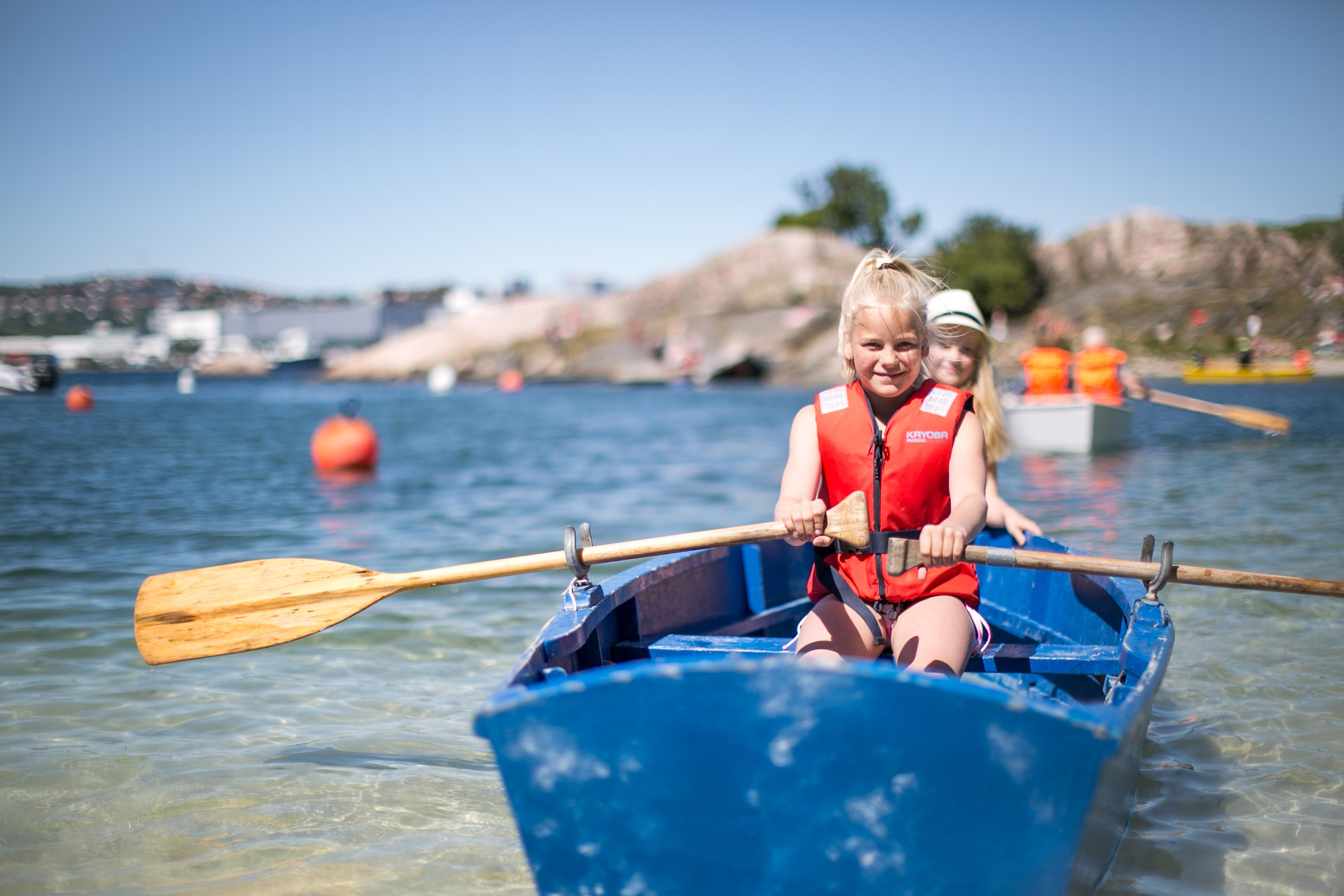 Two children in a rowing boat near Bragdøya outside of Kristiansand, Southern Norway