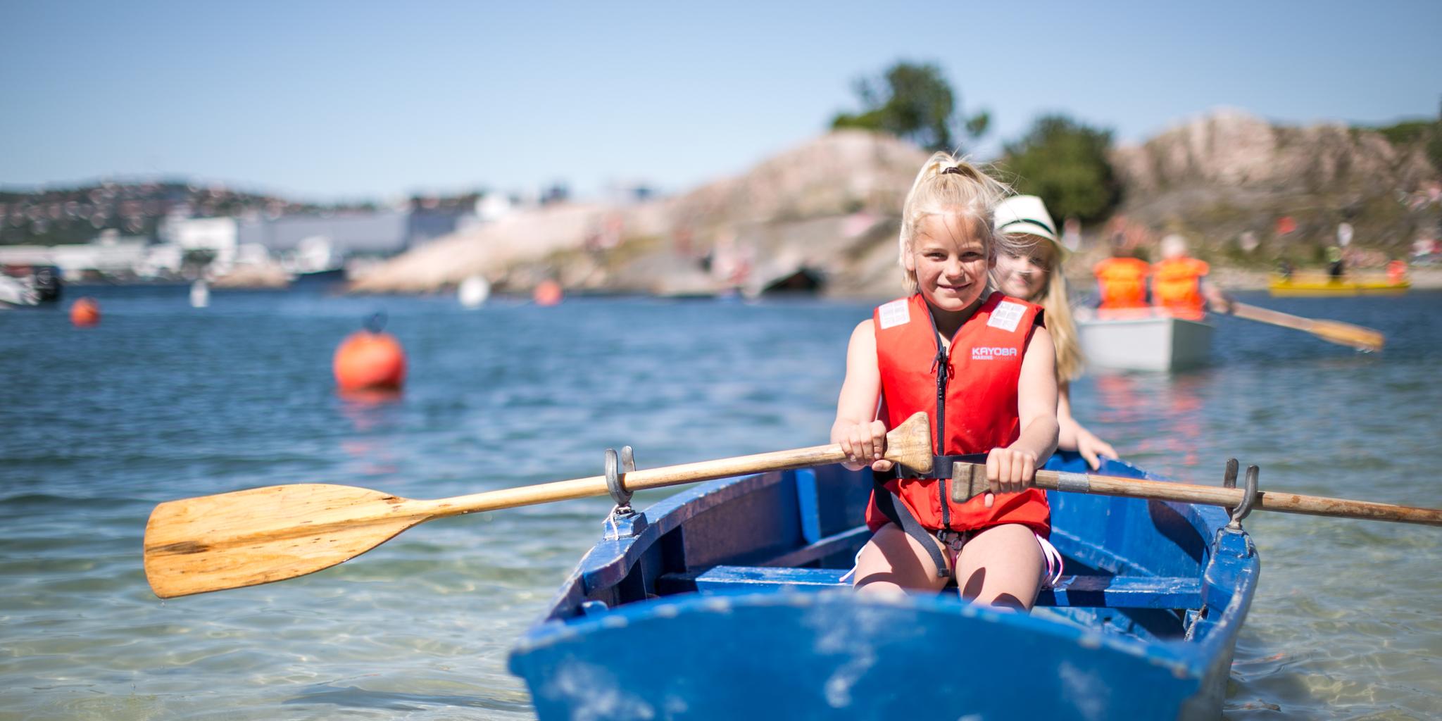 Two children in a rowing boat near Bragdøya outside of Kristiansand, Southern Norway