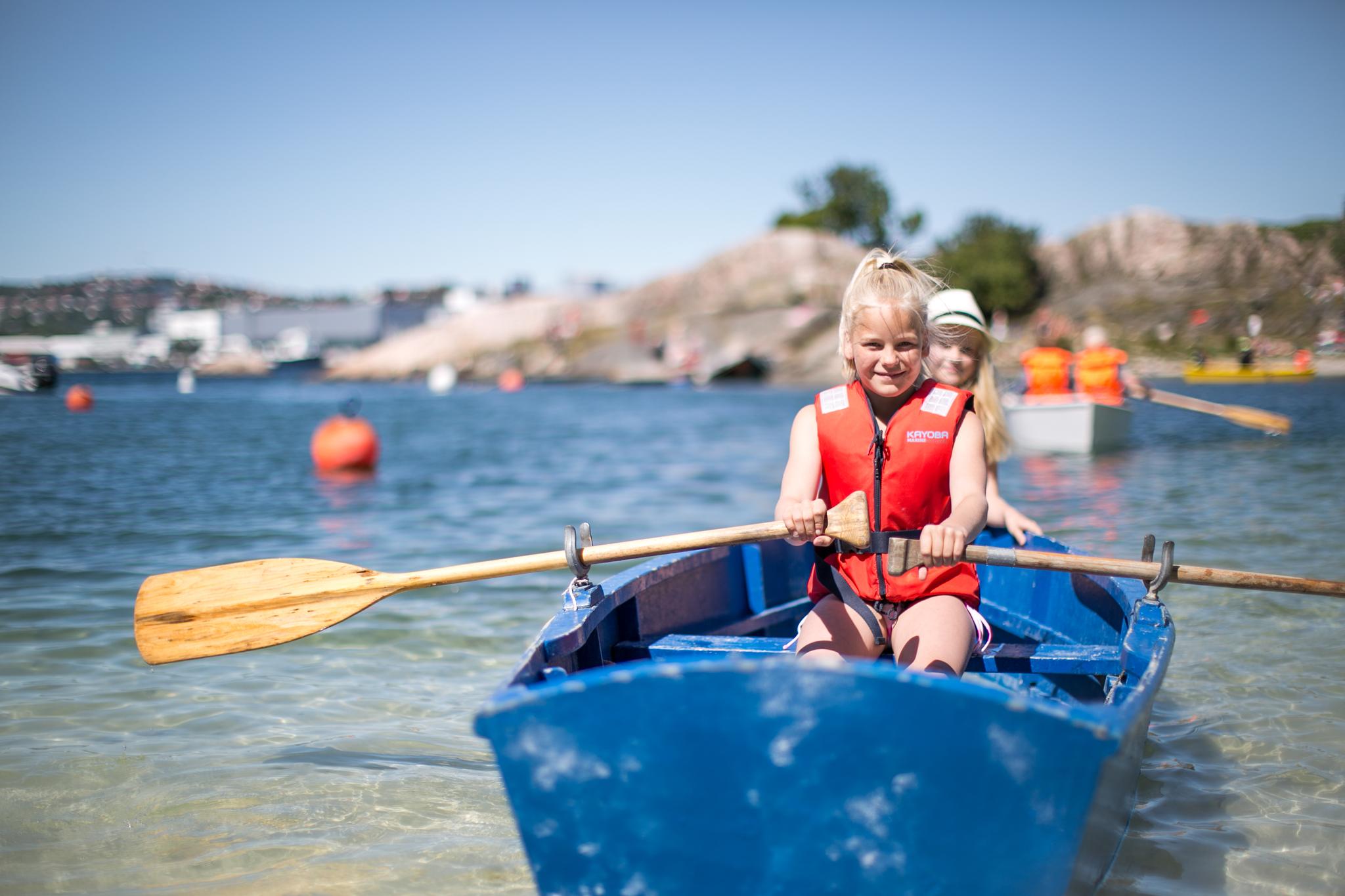 Two children in a rowing boat near Bragdøya outside of Kristiansand, Southern Norway
