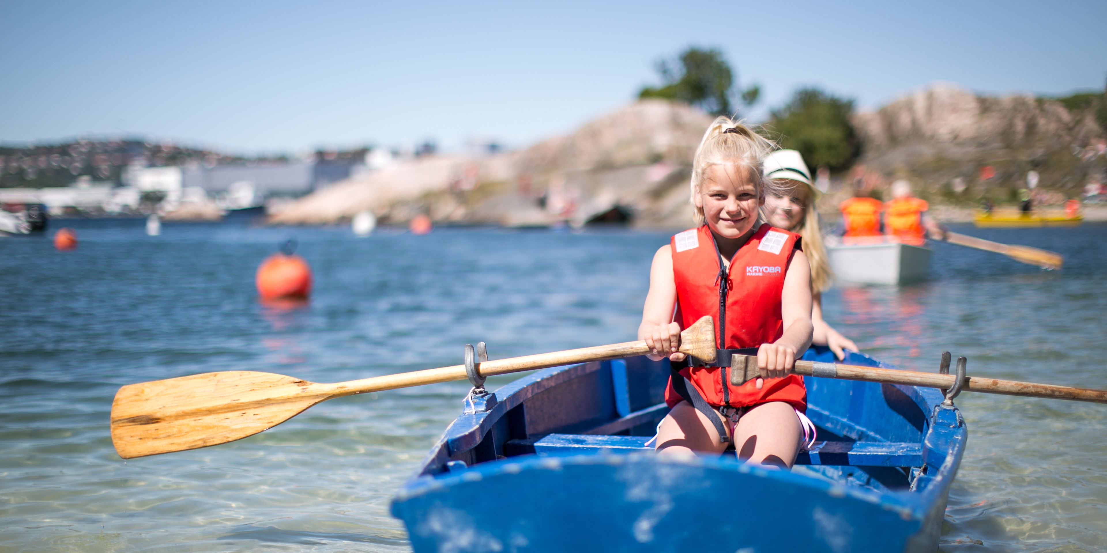 Two children in a rowing boat near Bragdøya outside of Kristiansand, Southern Norway